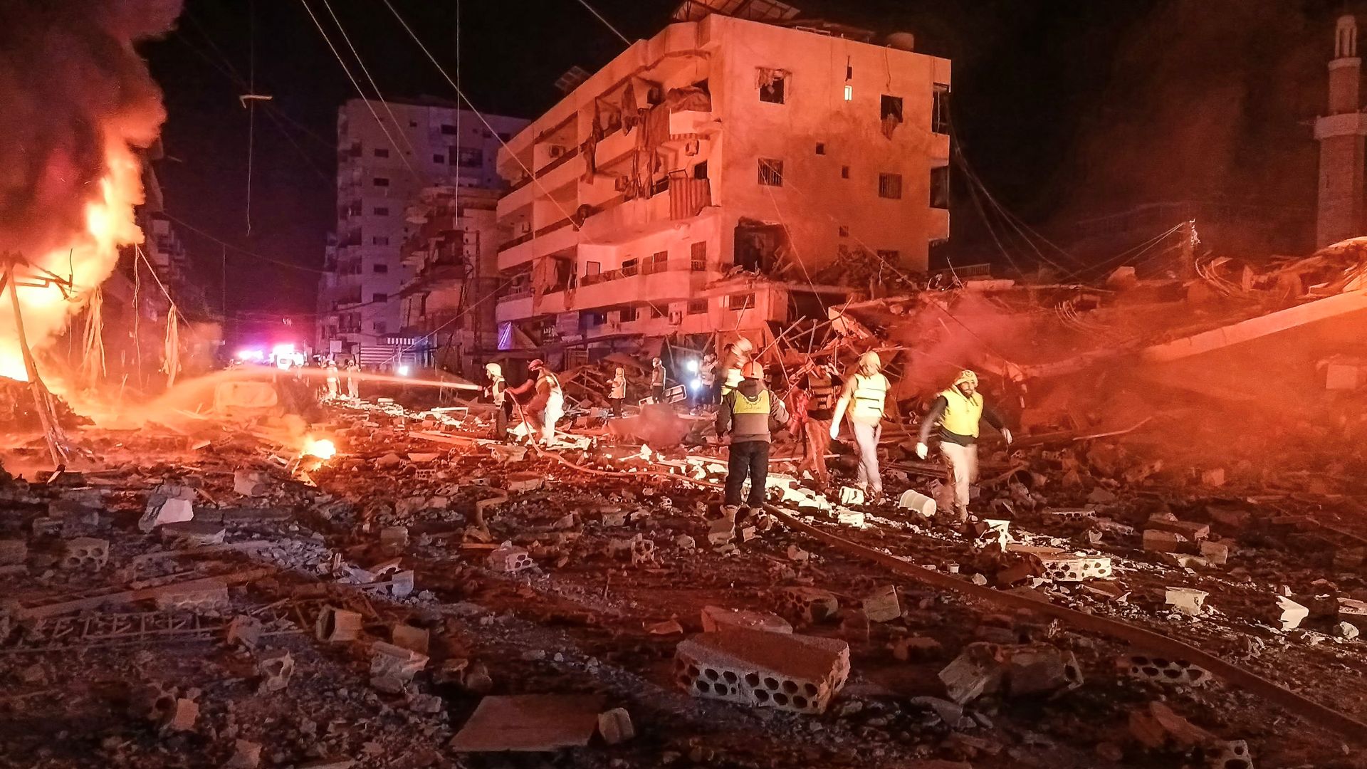 First responders battle flames following an Israeli airstrike that targeted the industrial zone in the southern Lebanese village of Abbasiyeh near Tyre on October 30, 2024, 