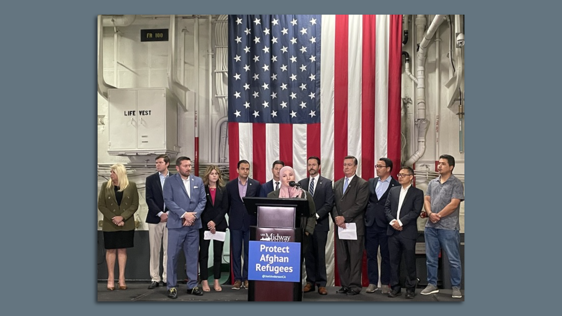 Homarya Yusufi, from the Partnership for a New America, urges support for the Afghan Adjustment Act on the USS Midway