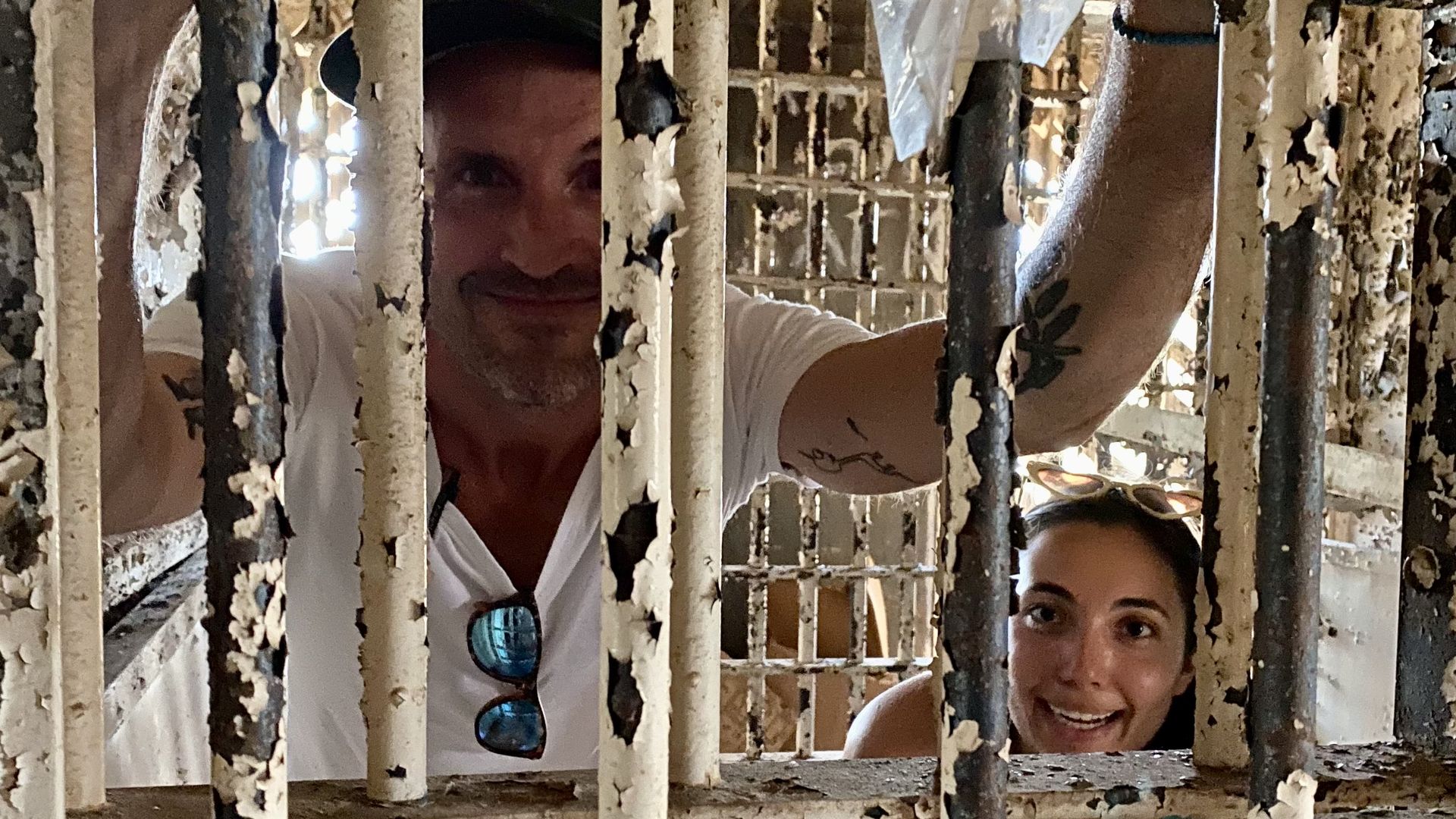 Ben and Selene behind rusty jail bars