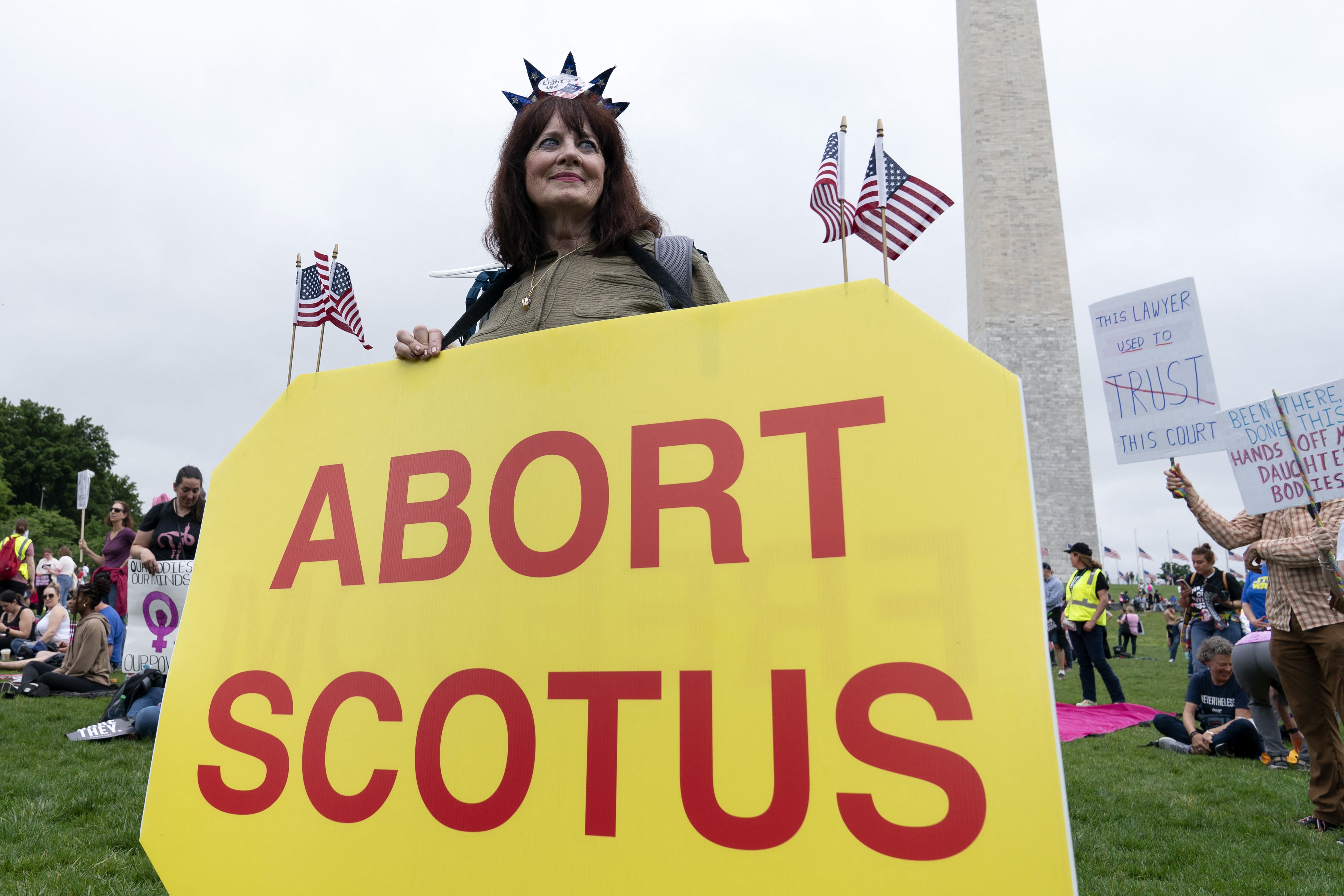 An abortion rights activist holding a sign at the Washington Monument on May 14.