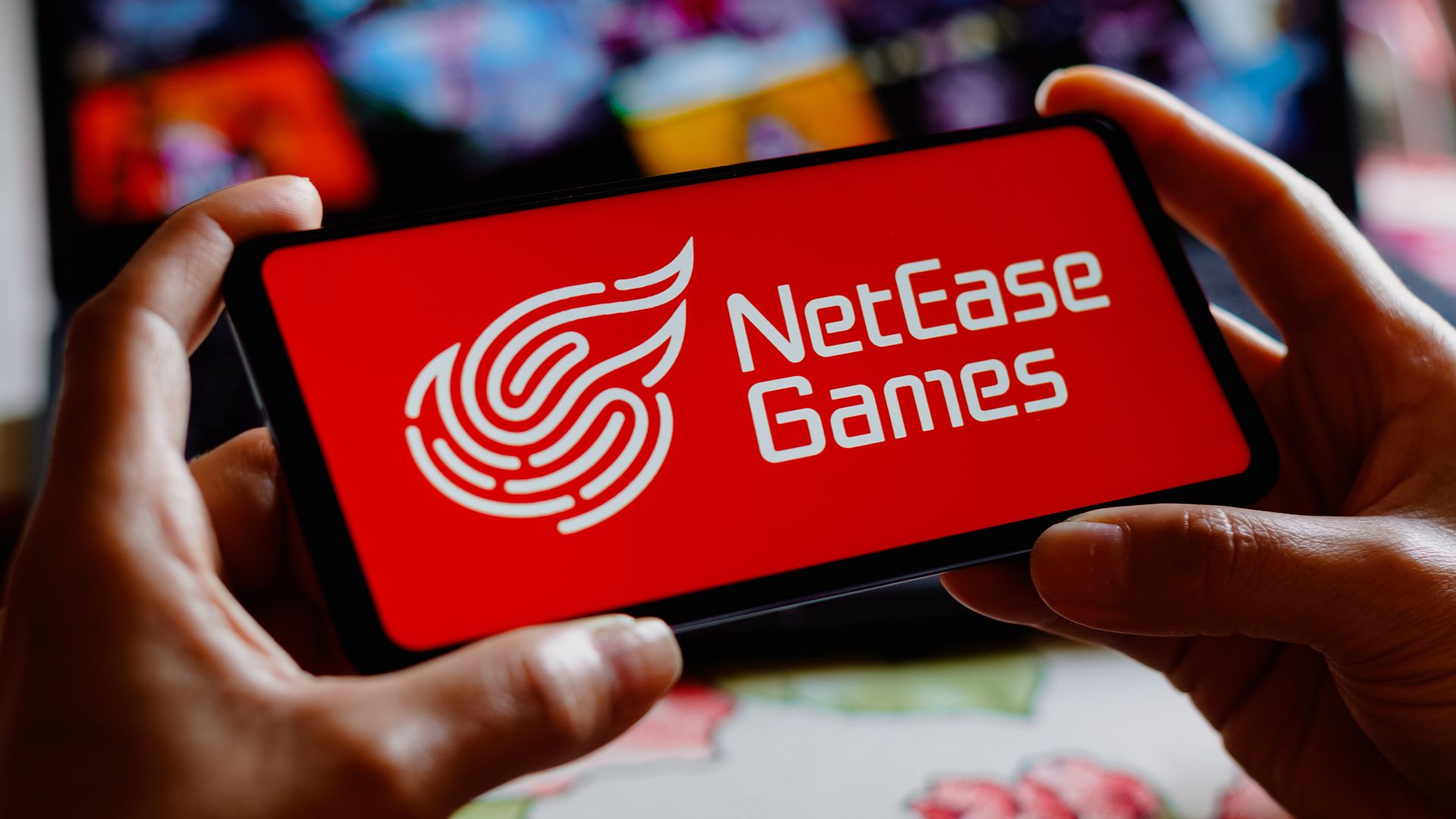 Photo of the NetEase logo displayed on a mobile phone