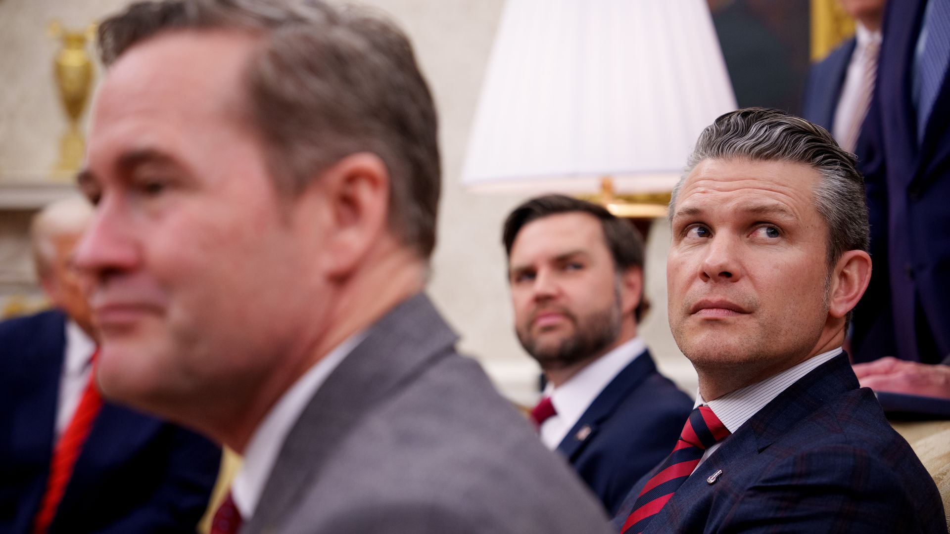 Pete Hegseth, JD Vance and Mike Waltz sit in the Oval Office.