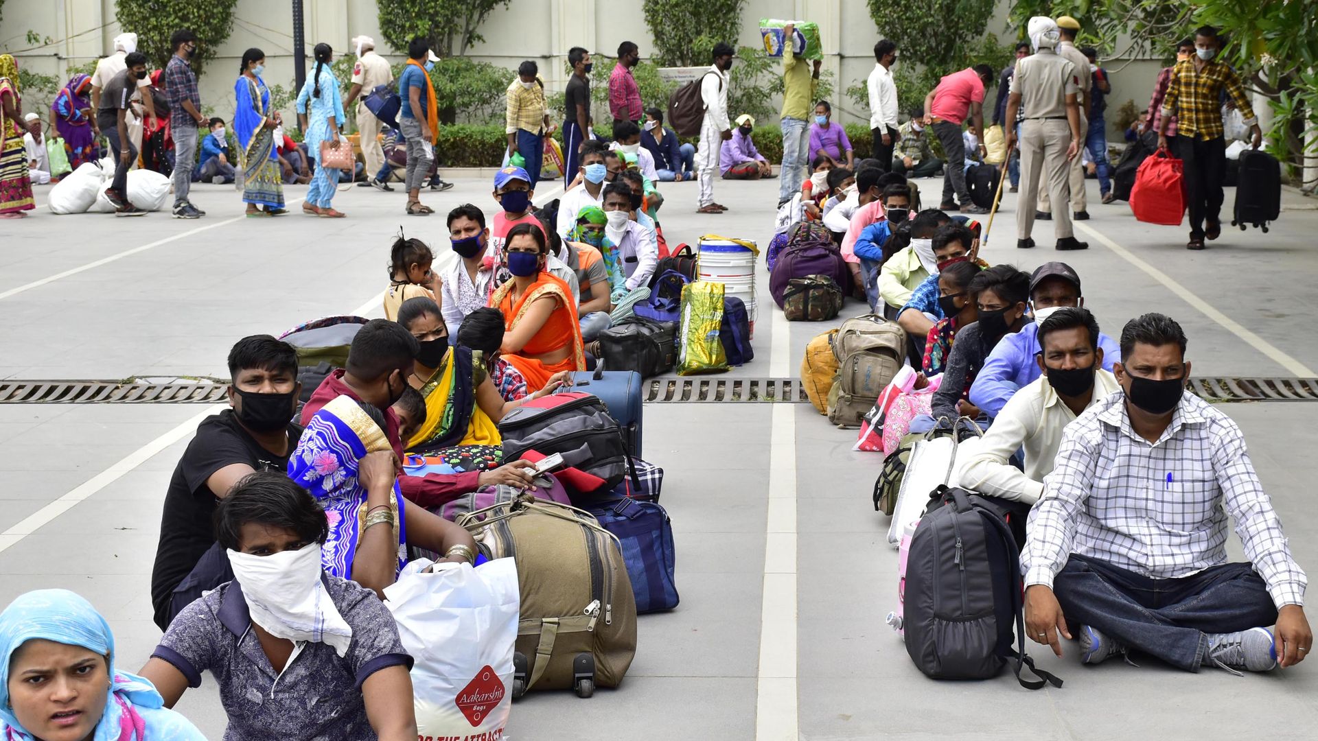 Two rows of people sit in a street