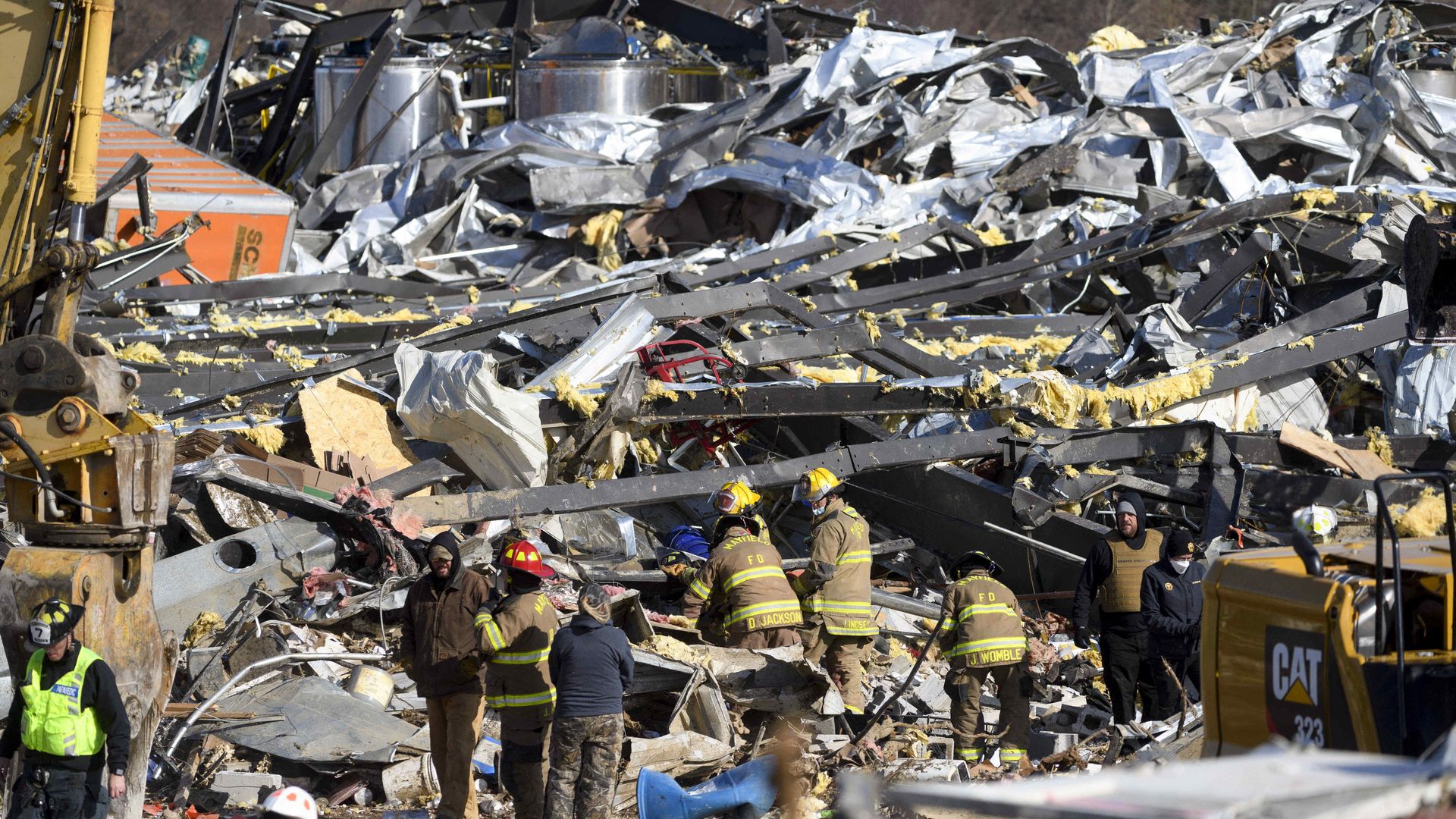 Emergency workers search through what is left of the Mayfield Consumer Products Candle Factory after it was destroyed by a tornado in Mayfield, Kentucky, on December 11, 2021.