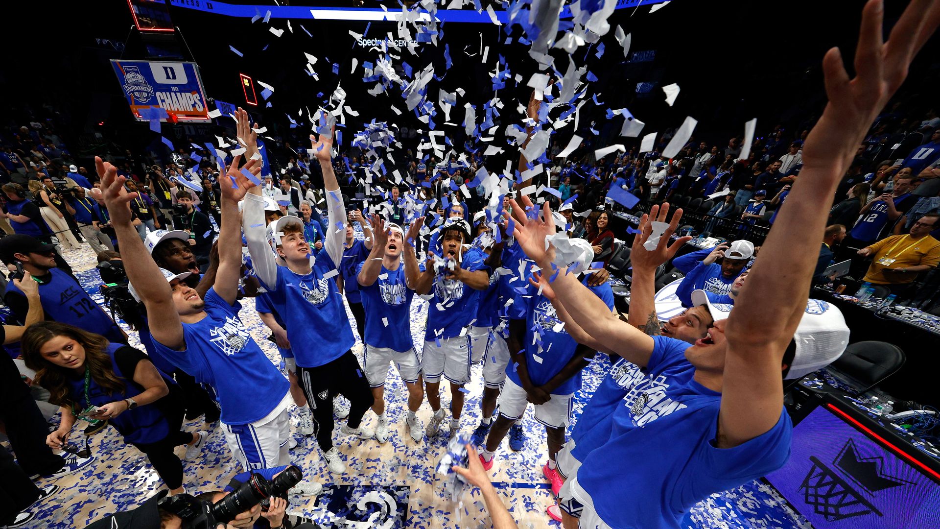 CHARLOTTE, NORTH CAROLINA - MARCH 15: Players of the Duke Blue Devils throw confetti up following their win against the Louisville Cardinals in the championship game of the ACC men's basketball tournament at Spectrum Center on March 15, 2025 in Charlotte, North Carolina. (Photo by Lance King/Getty I