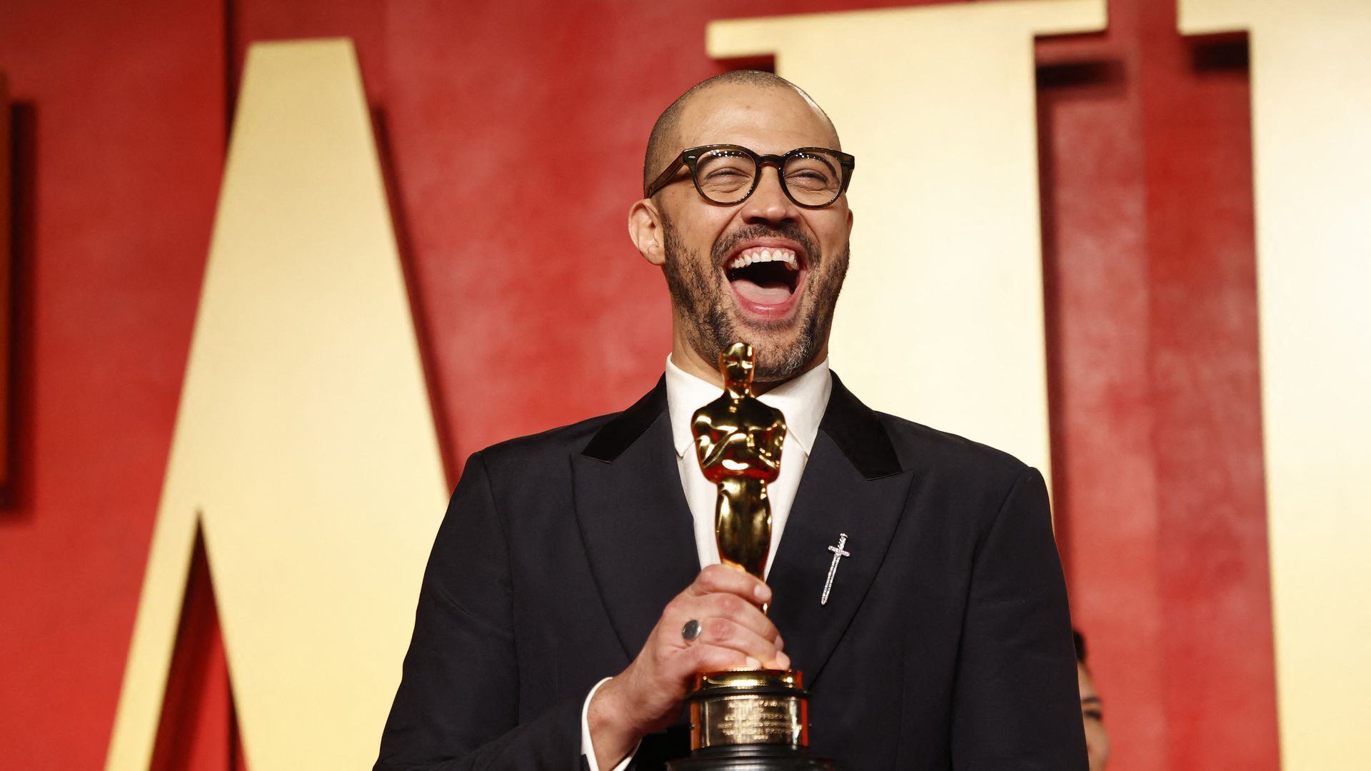 Cord Jefferson holds his Oscar