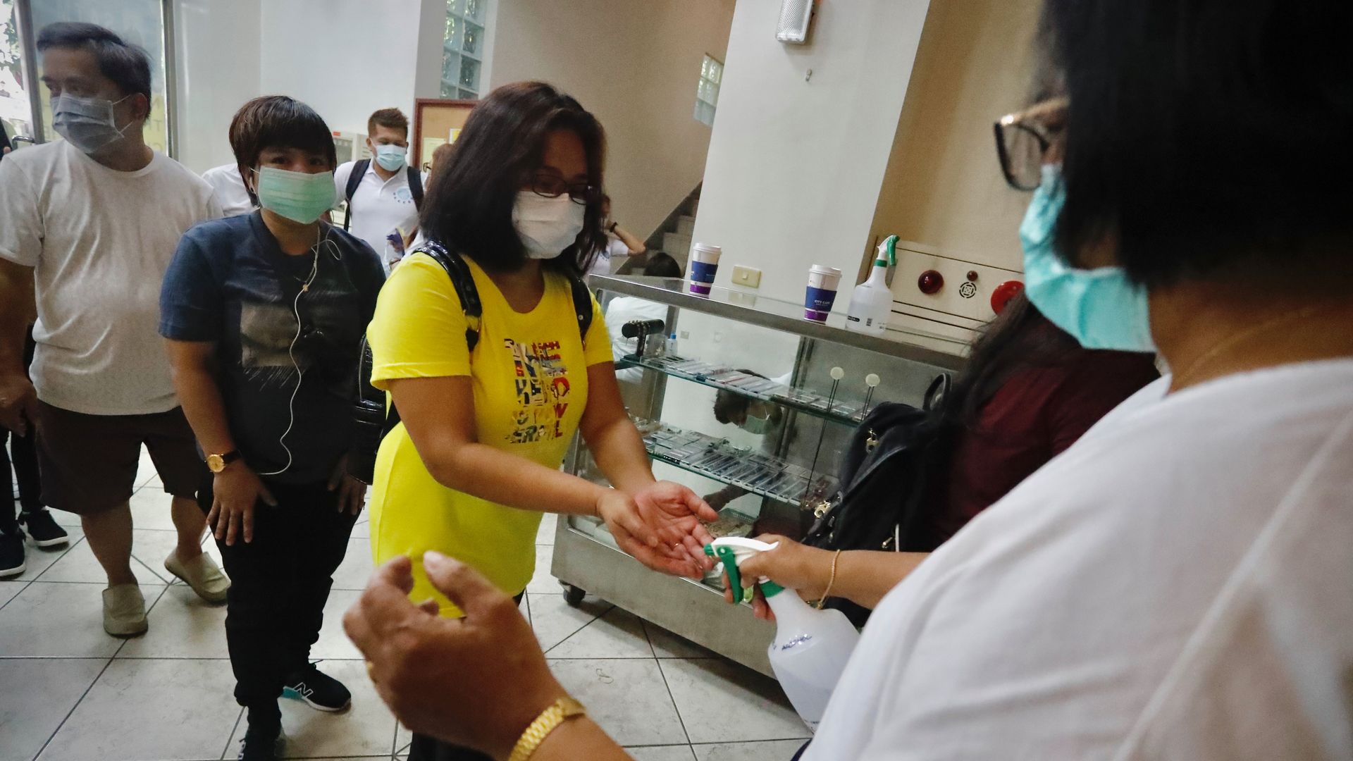 Catholics go through containment protocols including body-temperature measurement and hands-sanitisation before entering the Saint Christopher Parish Church, Taipei City, Taiwan, 26 July 2020. 