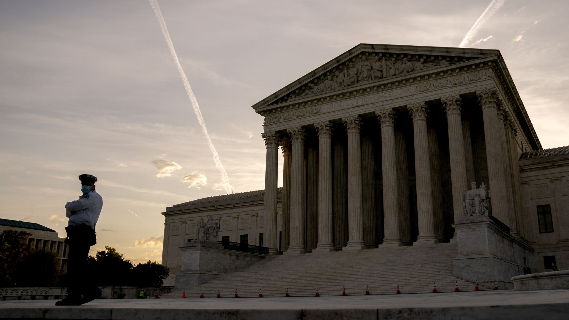 A police officer stands in front of the U.S. Supreme Court 