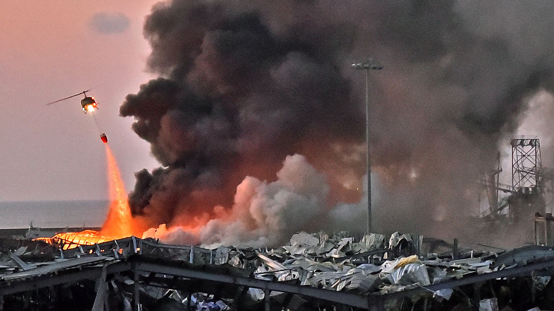 A helicopter surveys the blast in beirut.
