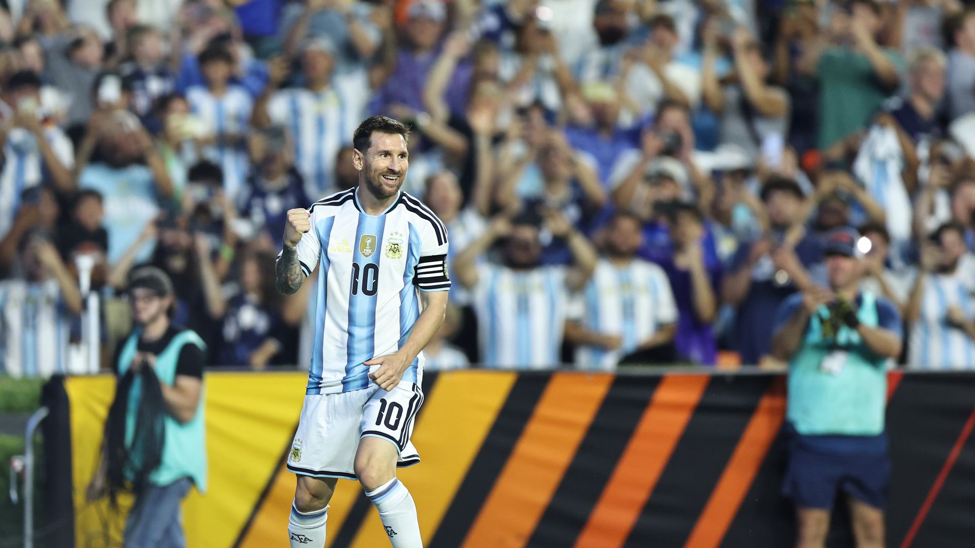 Lionel Messi in his Argentina uniform celebrates on the soccer pitch.