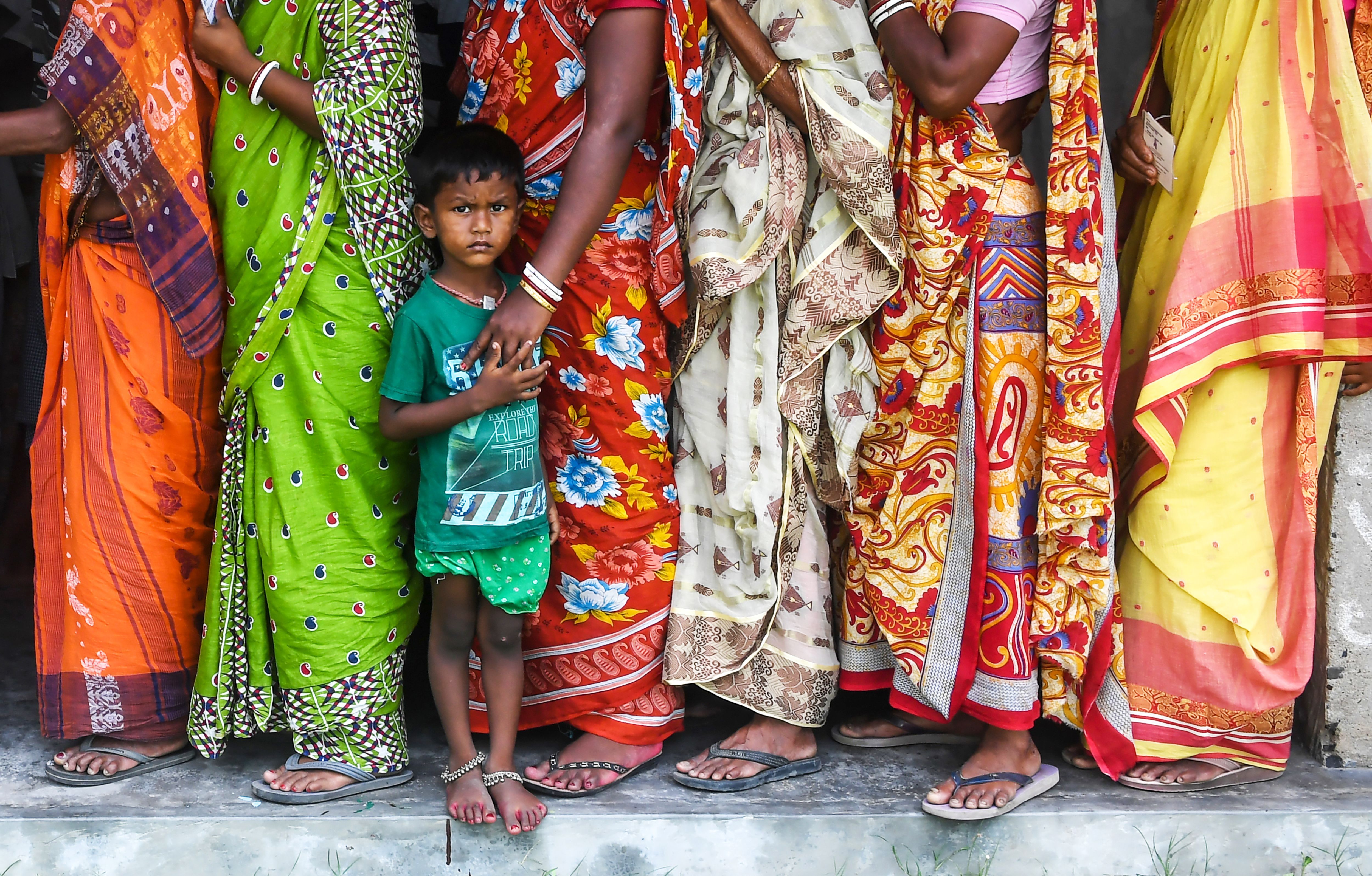 Indian voters queue to cast their votes in the Ghoramara island around 110 km south of Kolkata on May 19, 2019.