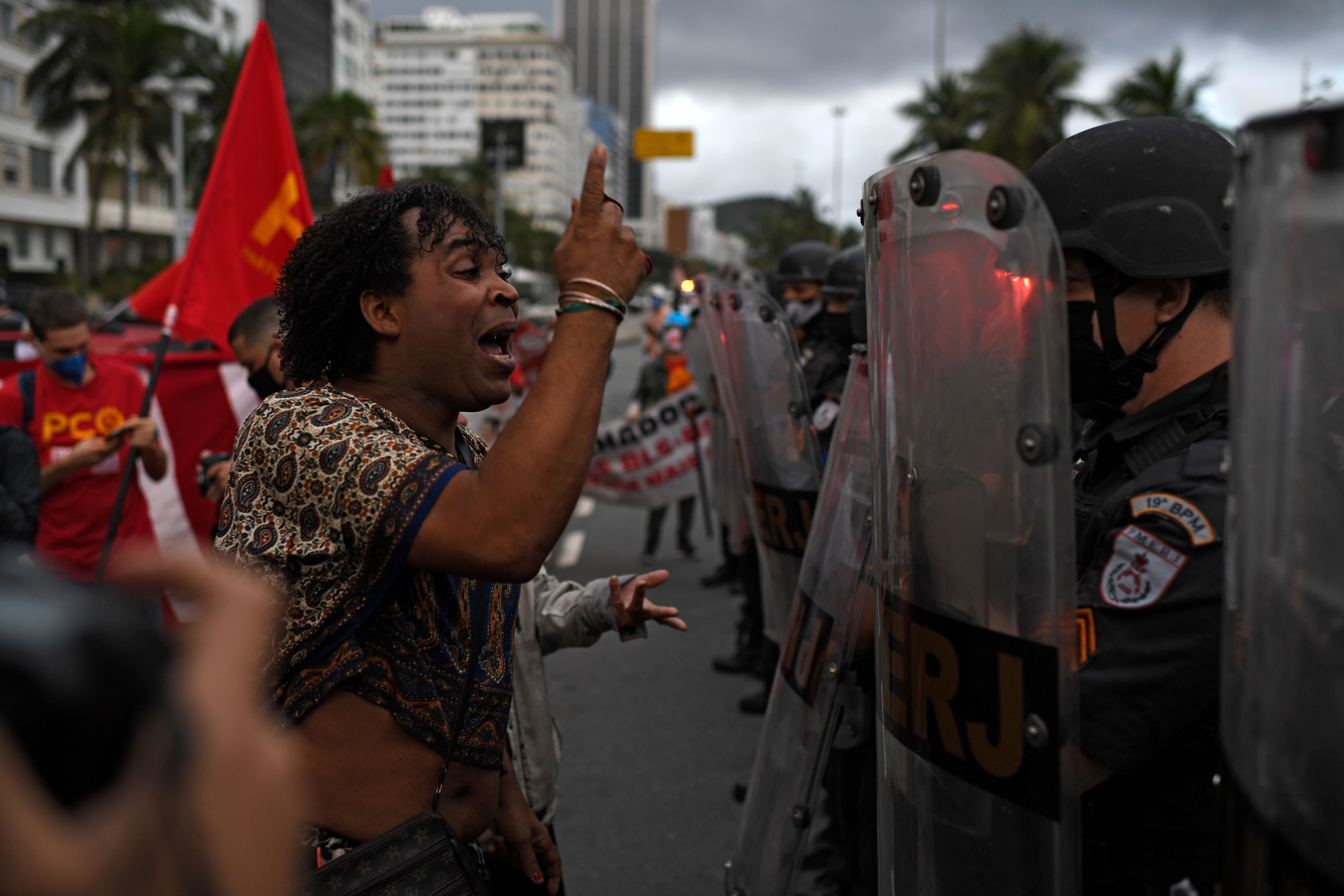 An LGBT activist argues with military police soldiers during a protest in Brazil