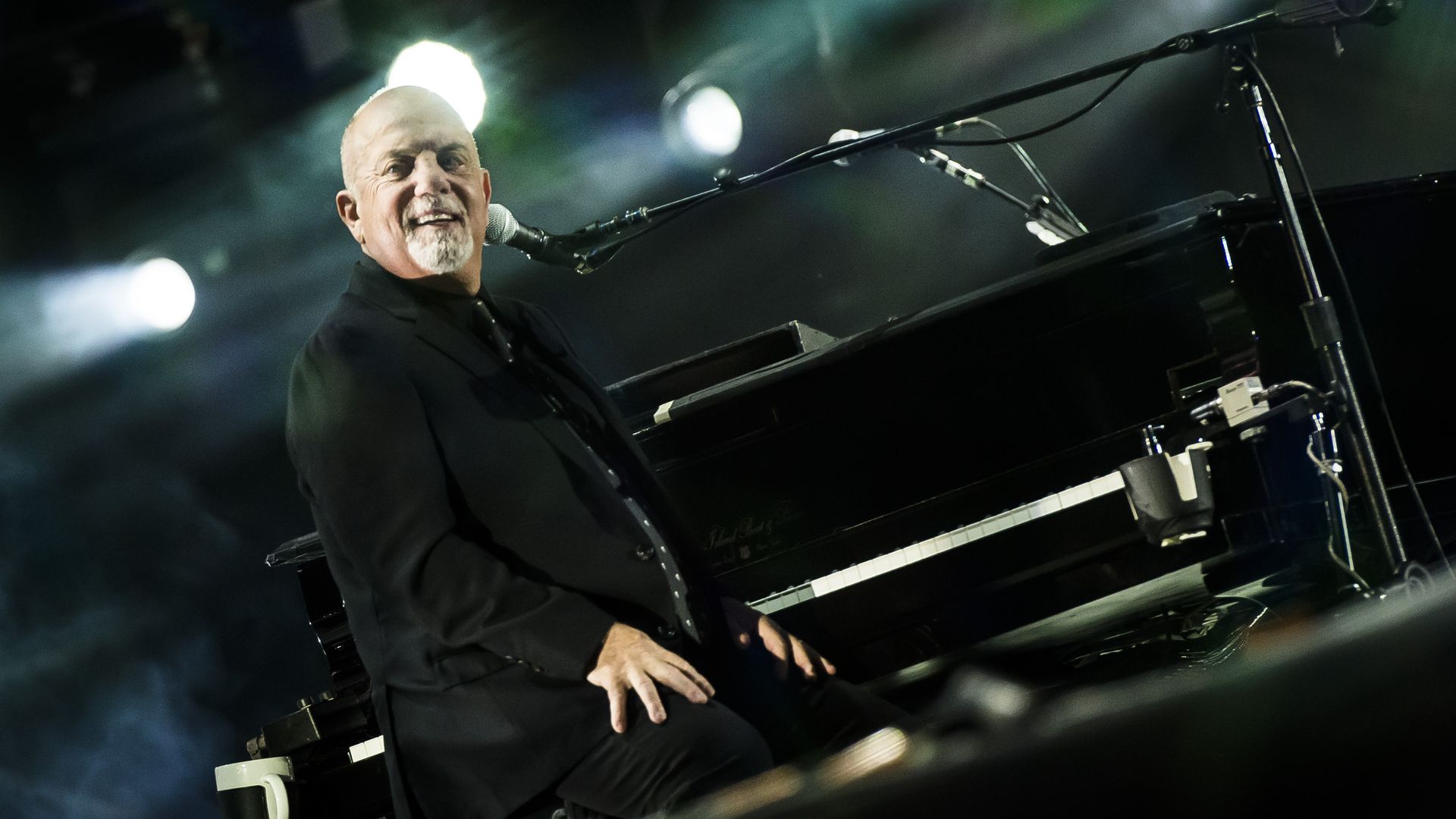 Billy Joel sits at his piano.