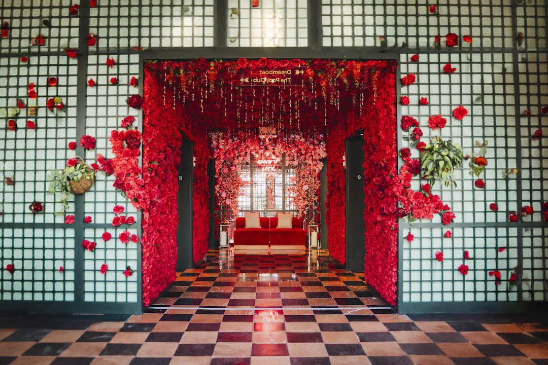 Photo shows the entrance to Virgin Hotel's Red Hot Holiday in New Orleans covered in red roses.