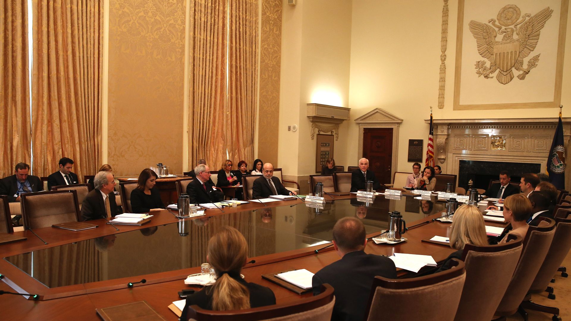 Federal Reserve Board Chairman Ben Bernanke (C) participates in a meeting of the Board of Governors at the Federal Reserve, October 24, 2013 in Washington DC 