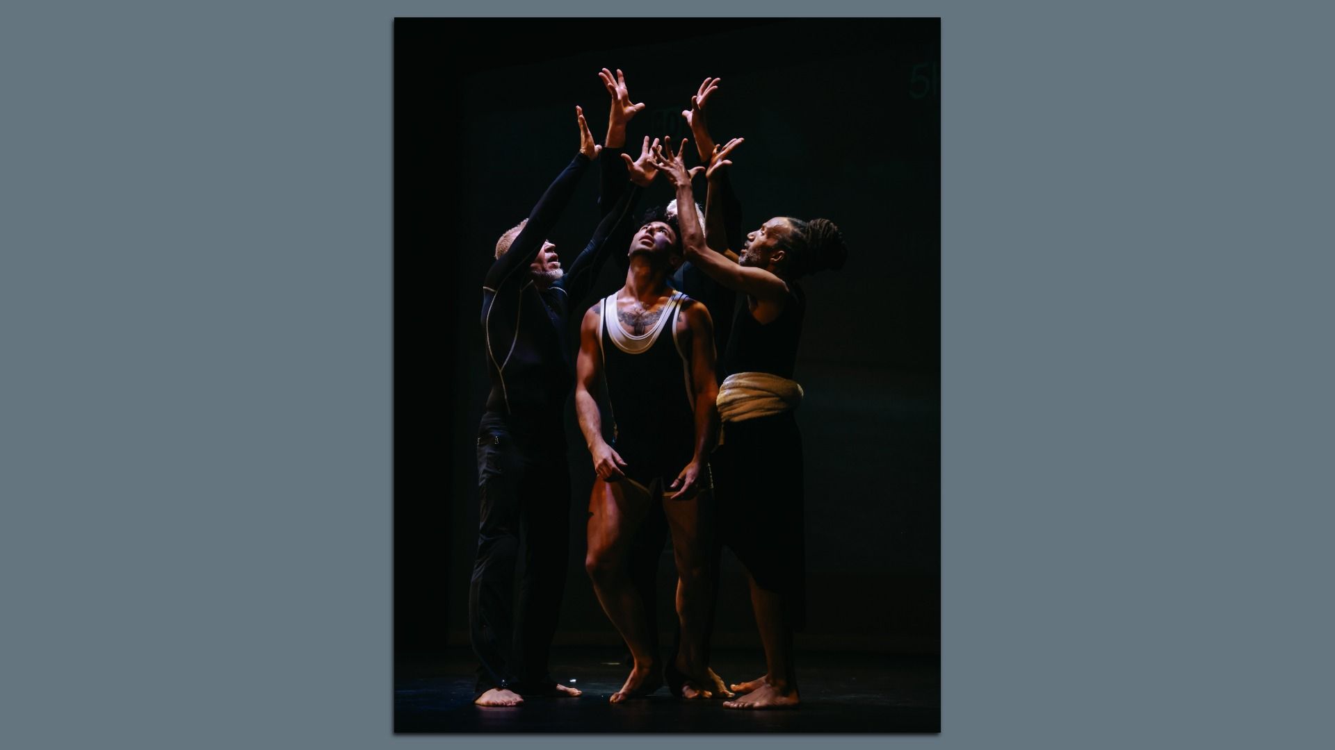 Performers with their hands in the air. 