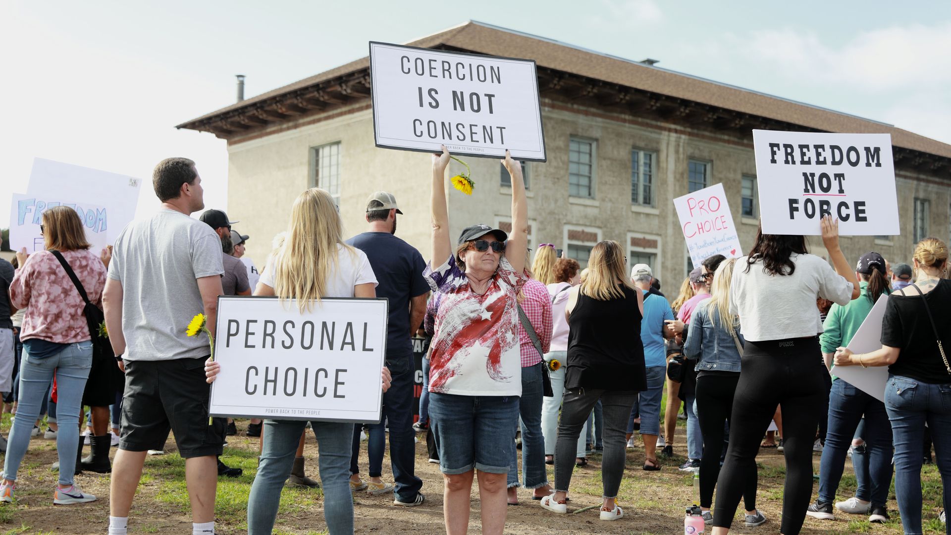 Anti-vaccine protesters stage a protest outside of the San Diego Unified School District office to protest a forced vaccination mandate for students