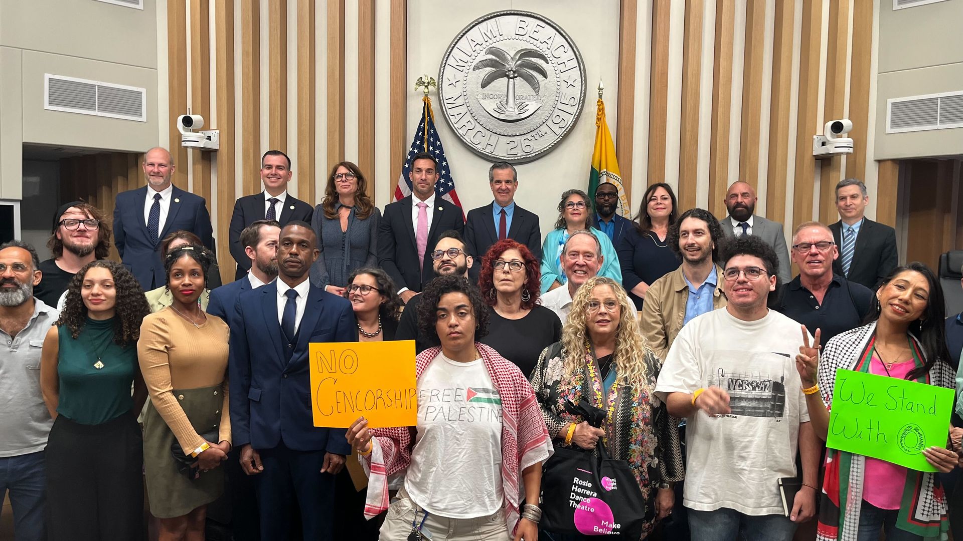 Group of people with some holding signs. 