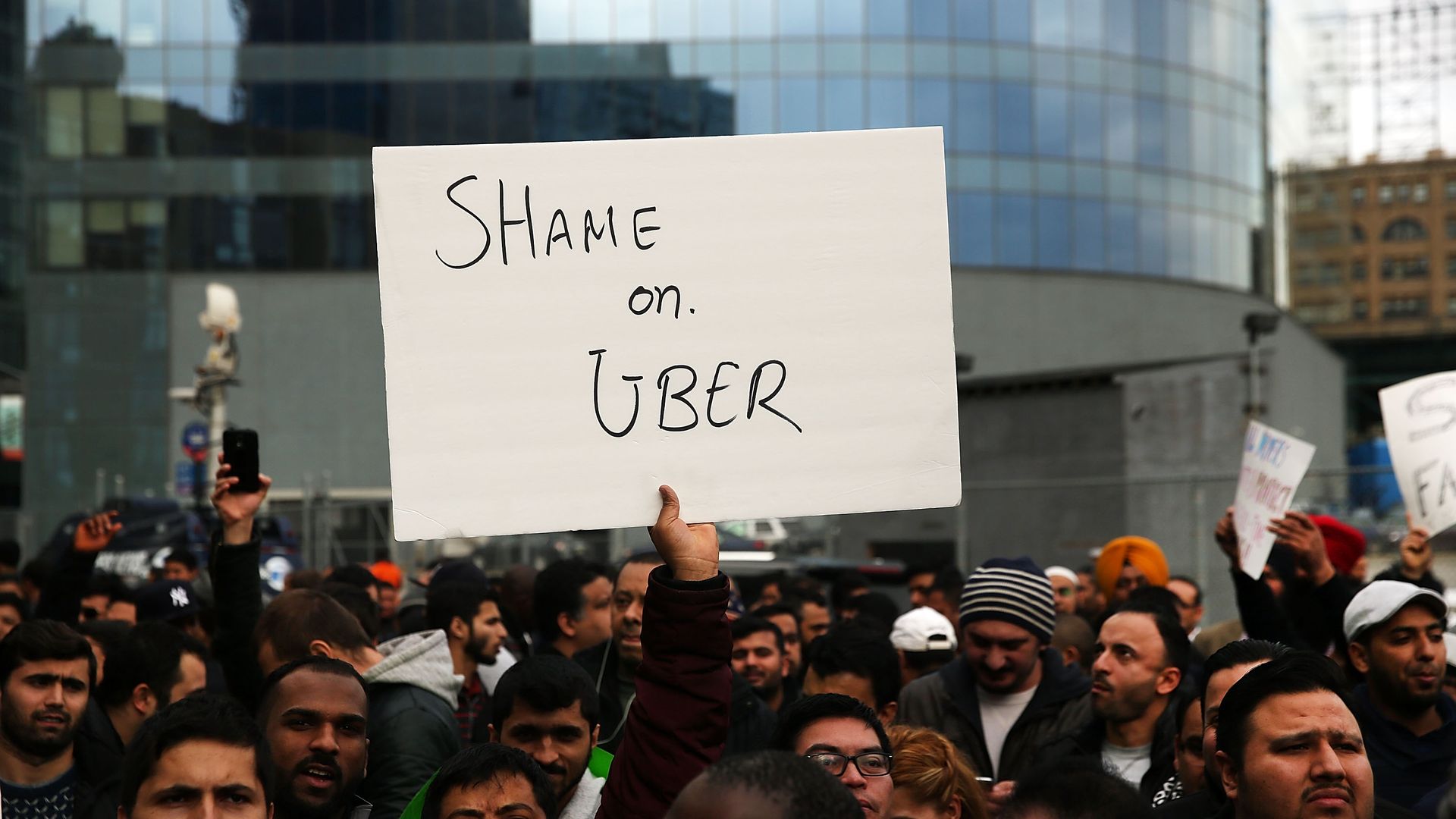 An Uber strike in new york. Sign that says shame on uber.