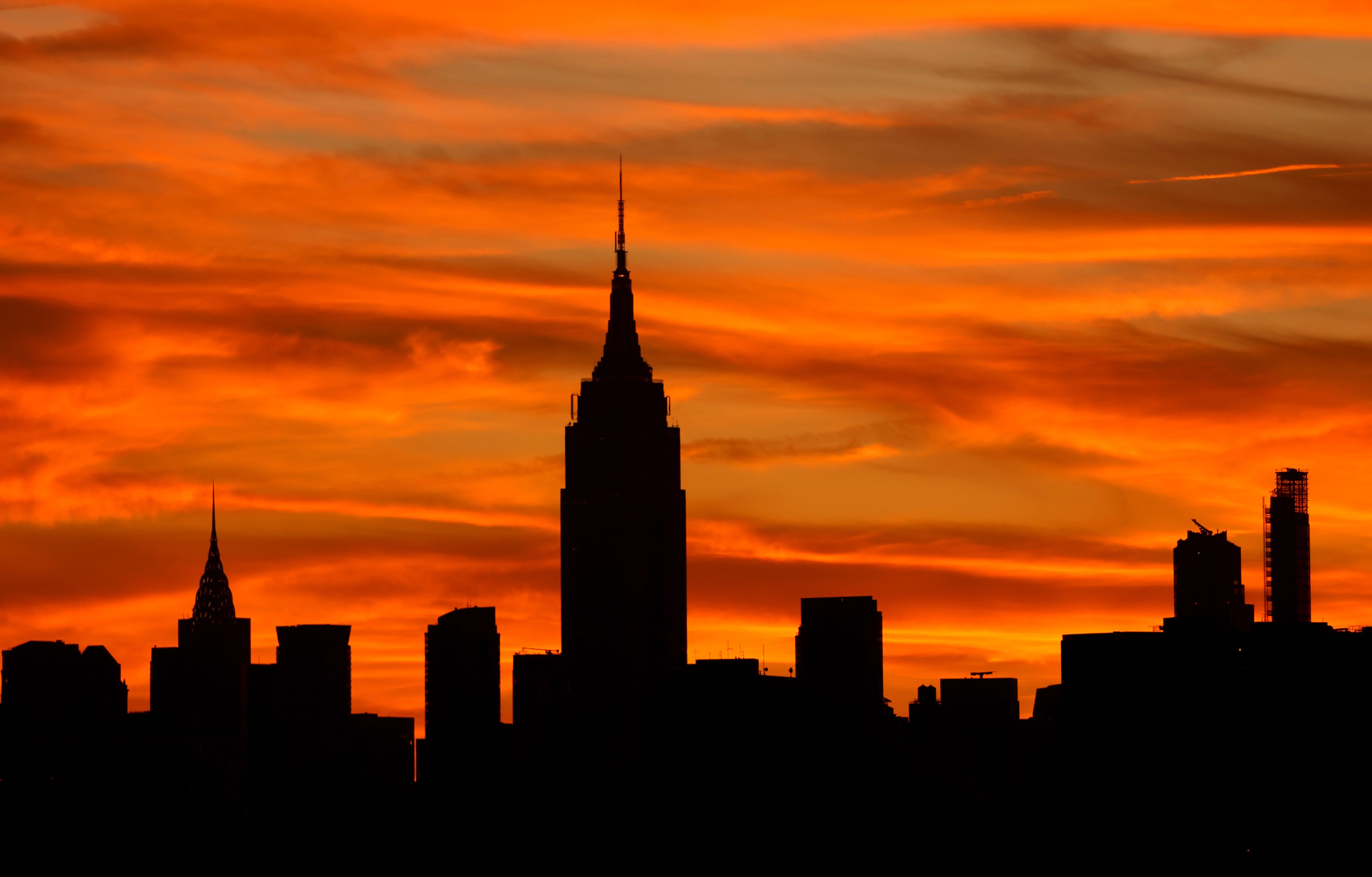 he sun rises behind the skyline of midtown Manhattan and the Empire State Building in New York City on September 21, 2025, as seen from Jersey City, New Jersey. (Photo by Gary Hershorn/Getty Images)