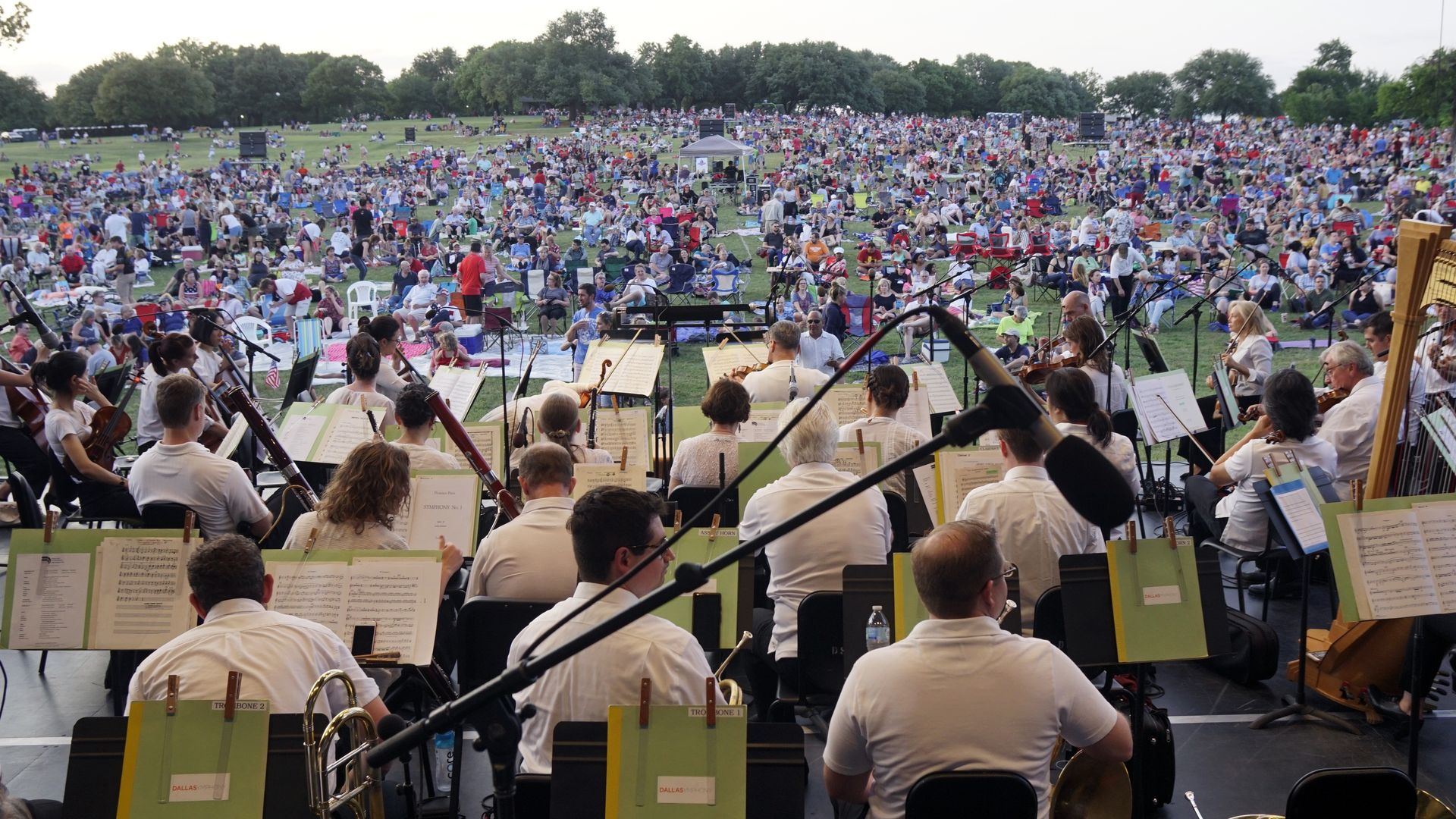 A symphony playing to a field of people