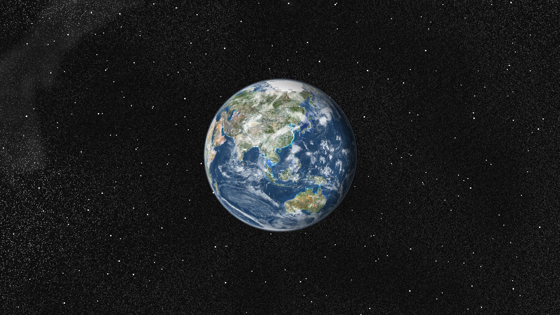 True color satellite image of the Earth centered on Asia and Oceania with cloud coverage. This image in orthographic projection was compiled from data acquired by LANDSAT 5 & 7 satellites