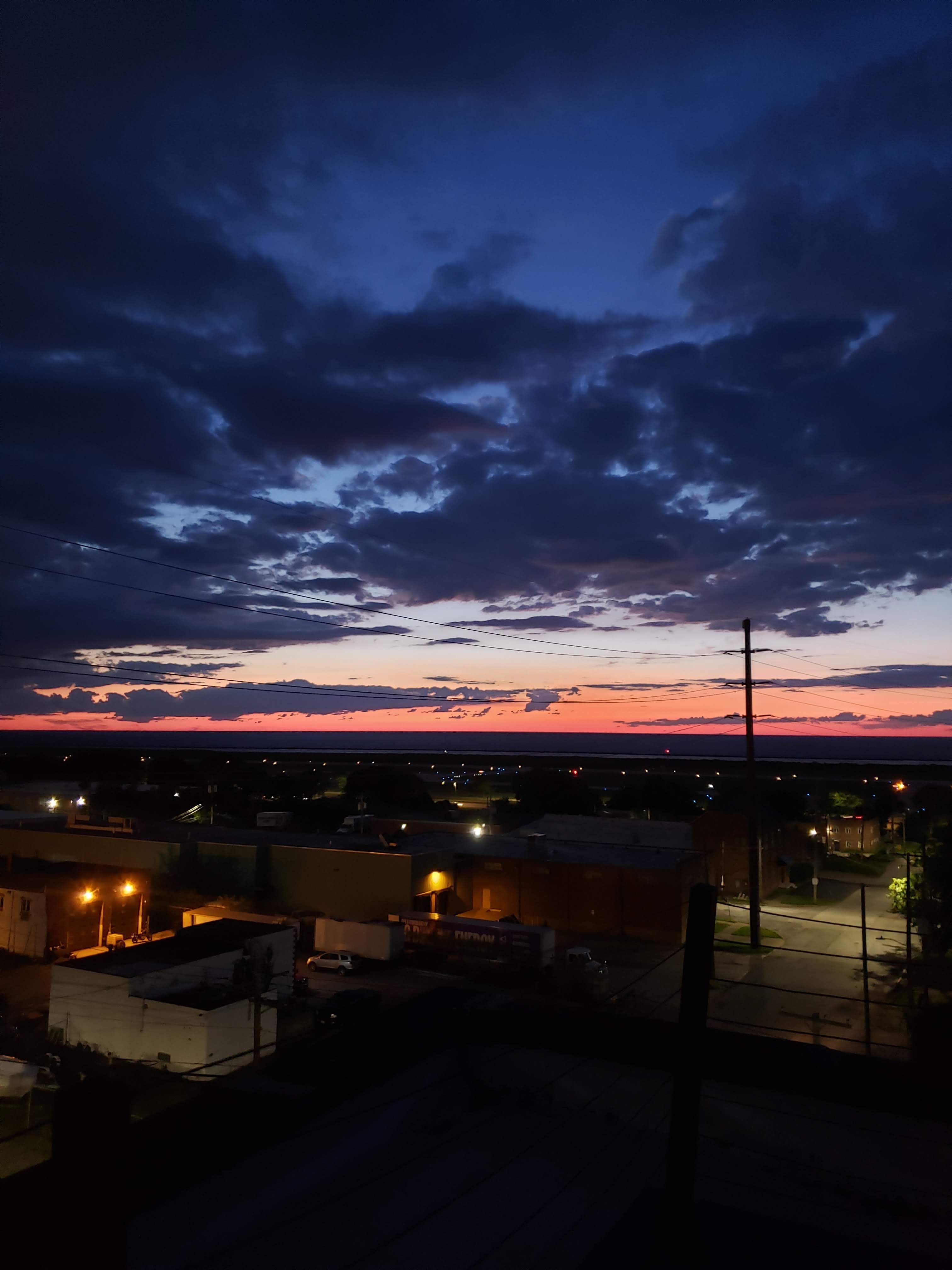Sunset from a rooftop in a city, warehouse area. 