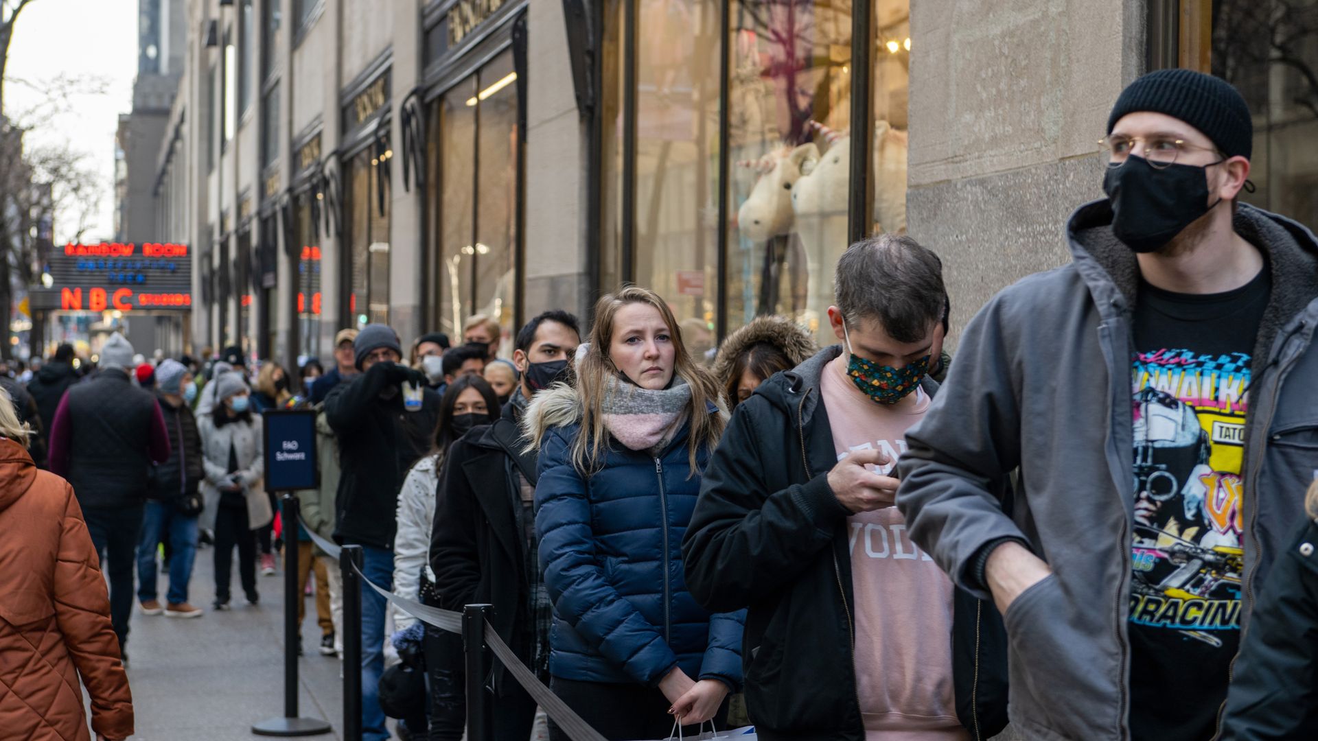 People wait in line to do last minute holiday