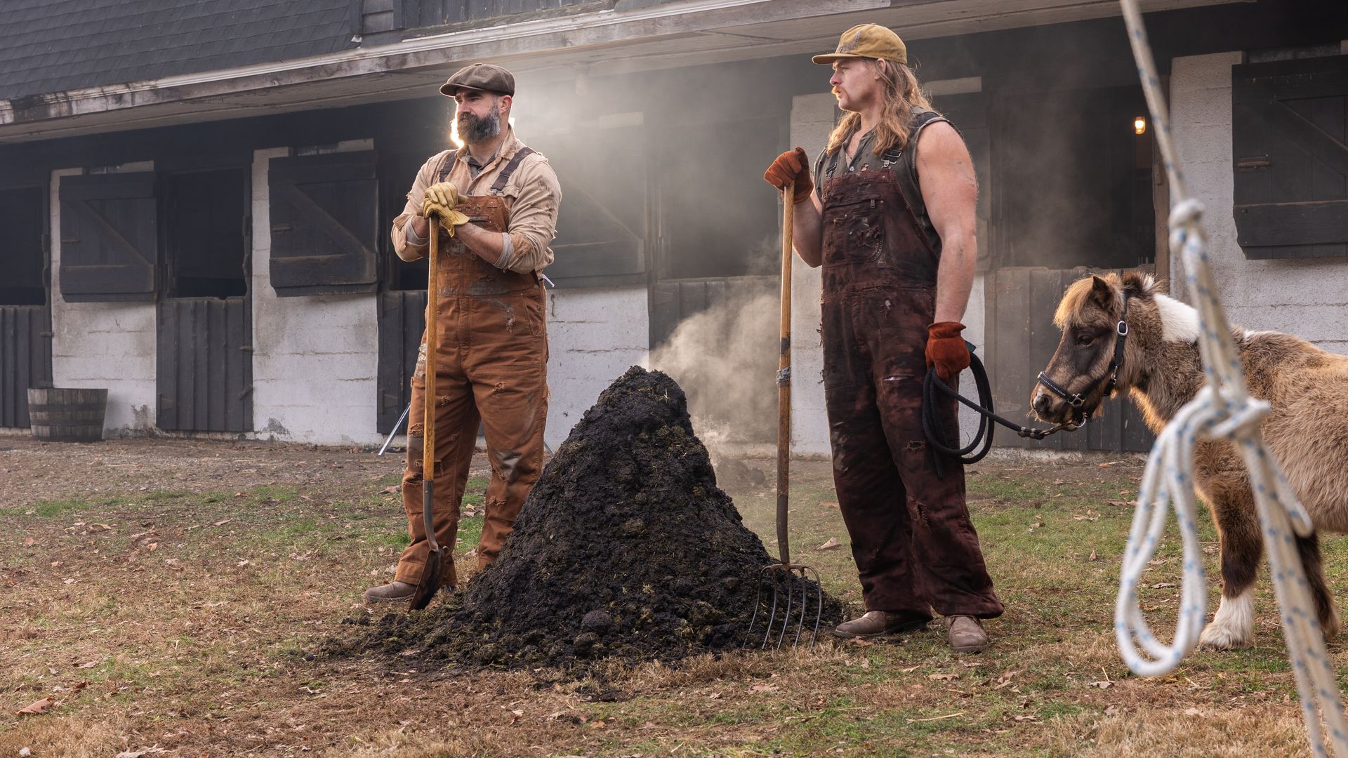 Left to right: Jason Kelce and Beau Allen standing next to a stinky pile of manure, and Doug the mini horse.
