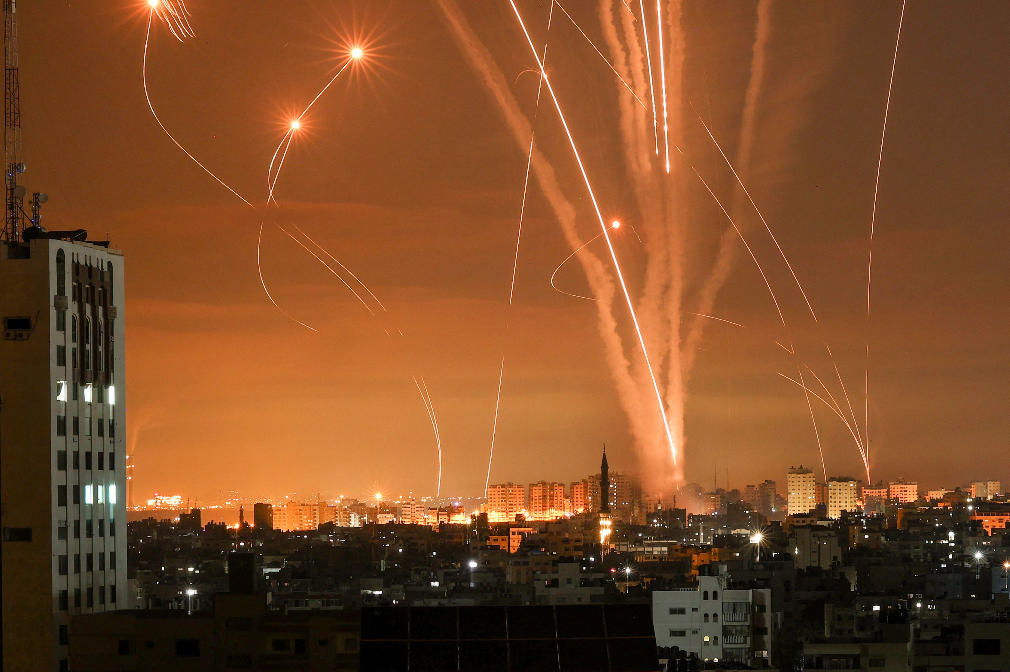 Rockets light up the night sky as they are fired towards Israel from Beit Lahia in the northern Gaza Strip on May 14, 2021