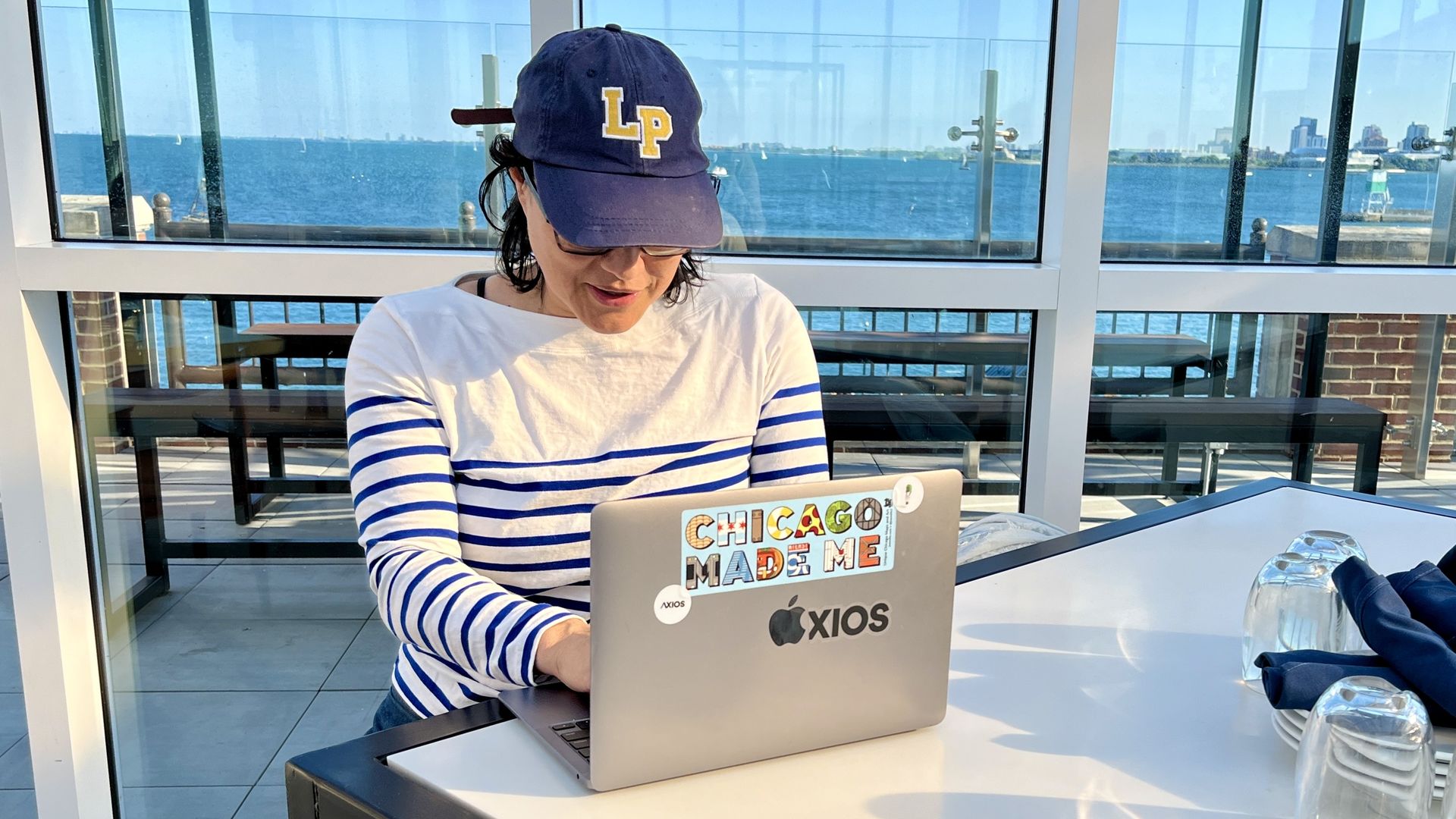 Photo of a woman working on a computer at a table 