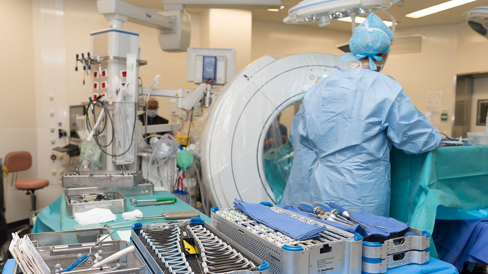 A surgeon preps for a procedure with supplies.