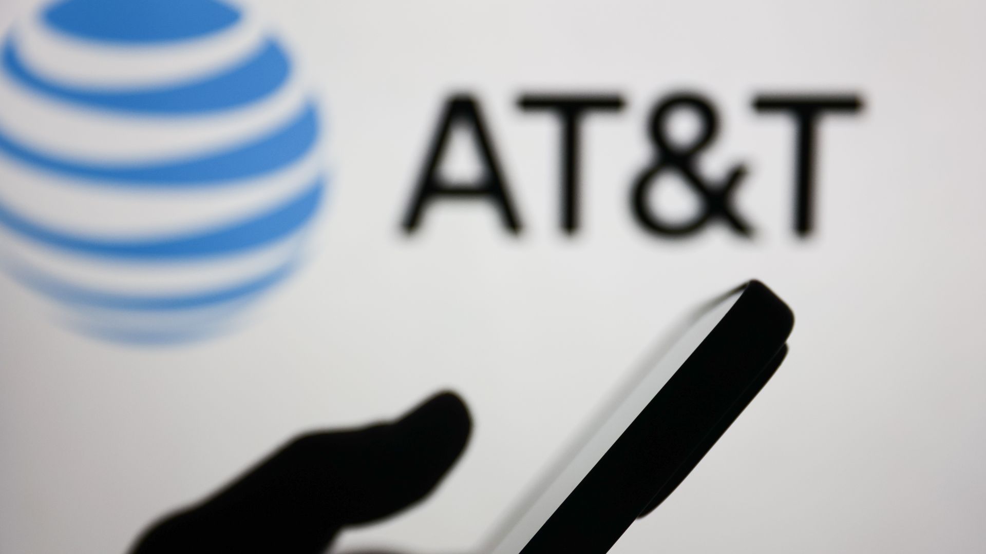 A silhouette of a phone with "at&t" in the background