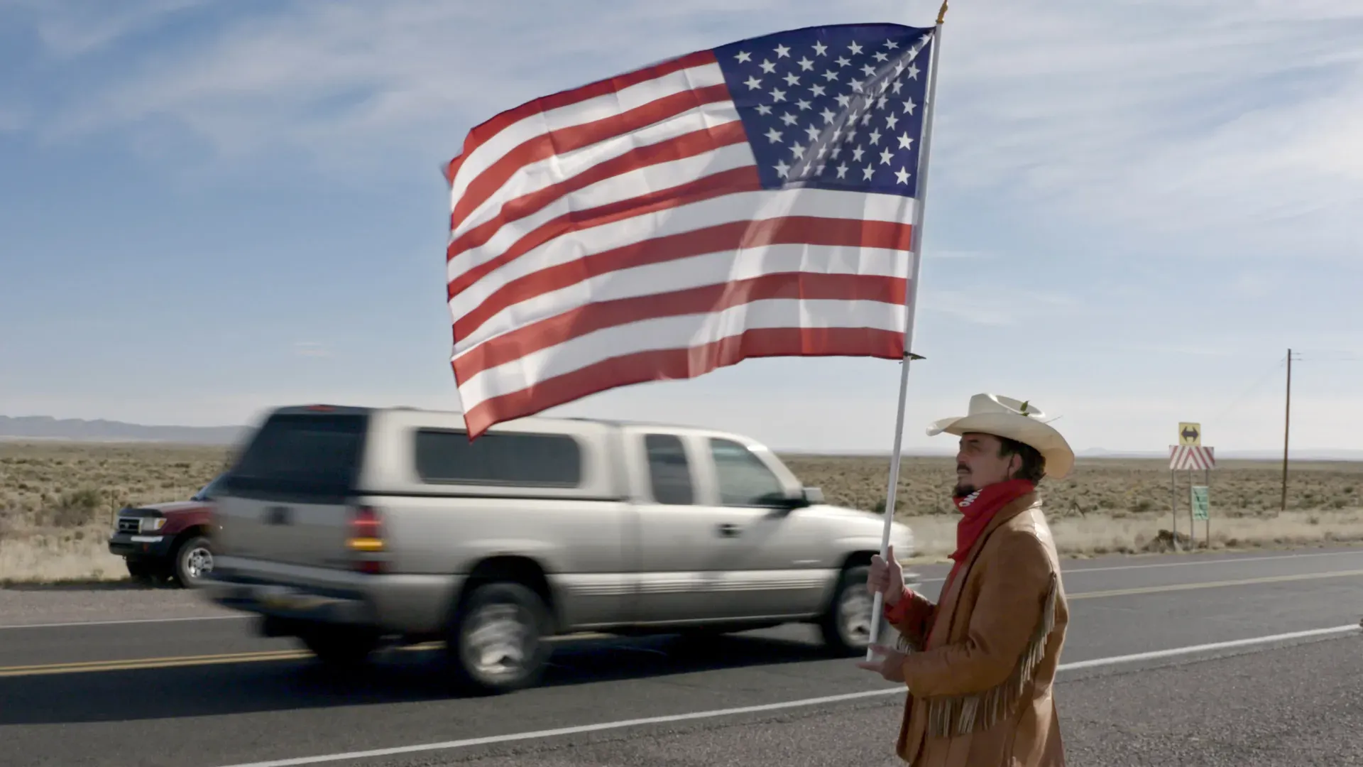 Paul Pino, a Trinity Test downwider from Carrizozo, N.M., protests outside the Trinity Test site as tourists travel to visit it. 