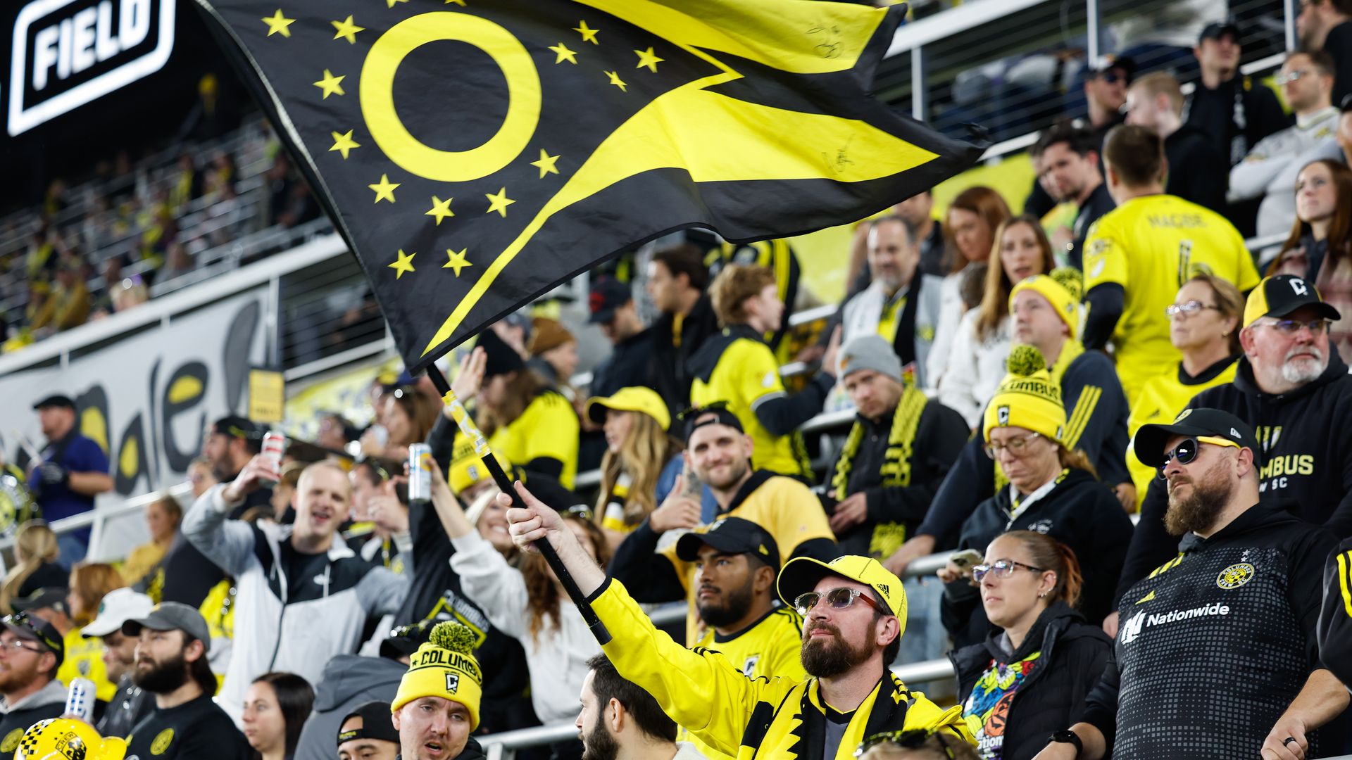 A Crew fan holds a black and gold Ohio state flag in the Lower.com Field stands