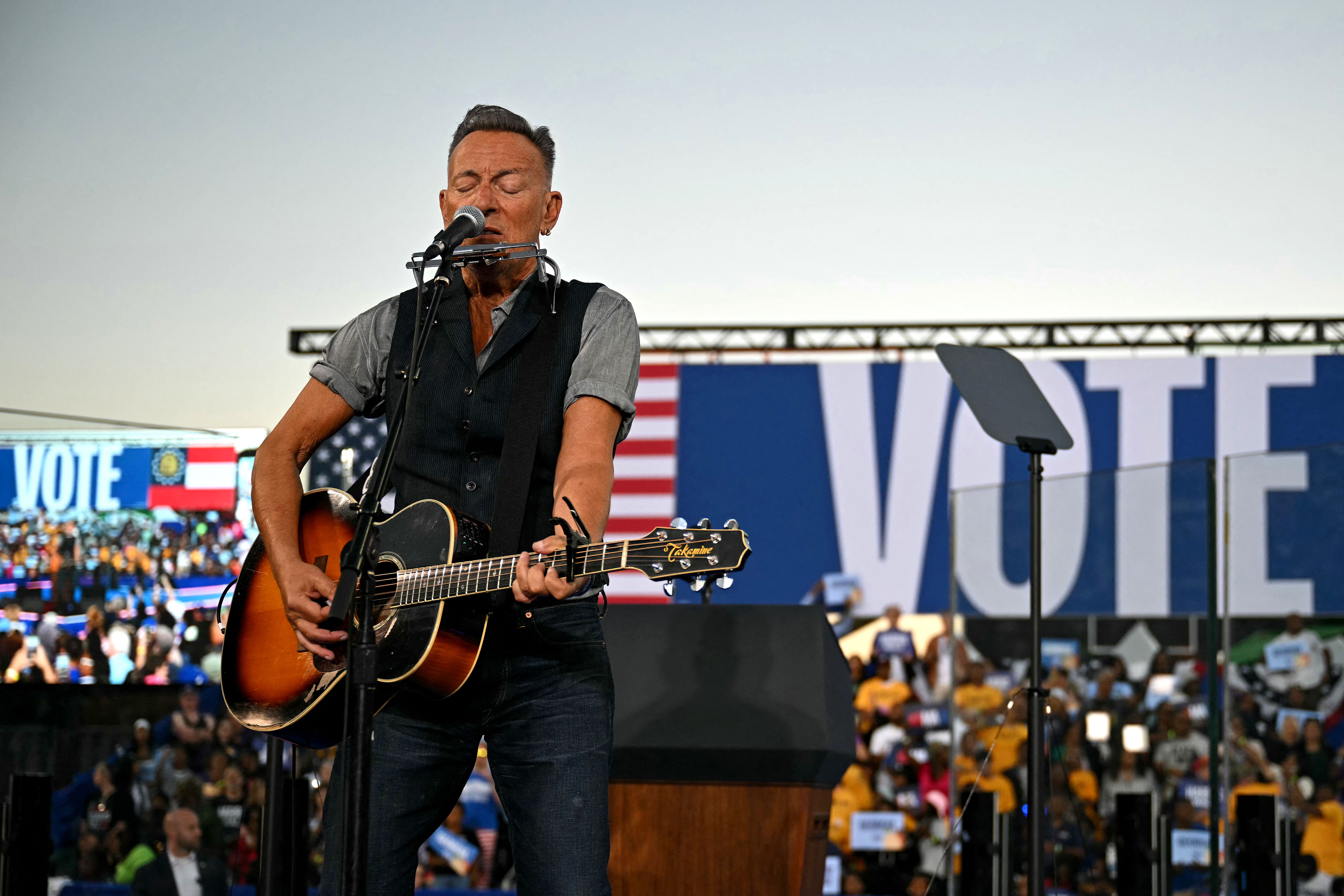 US musician Bruce Springsteen performs during a campaign rally with former US President Barack Obama supporting US Vice President and Democratic presidential candidate Kamala Harris at the James R Hallford Stadium in Clarkston, Georgia on October 24, 2024. (Photo by Drew ANGERER / AFP) (Photo by DRE