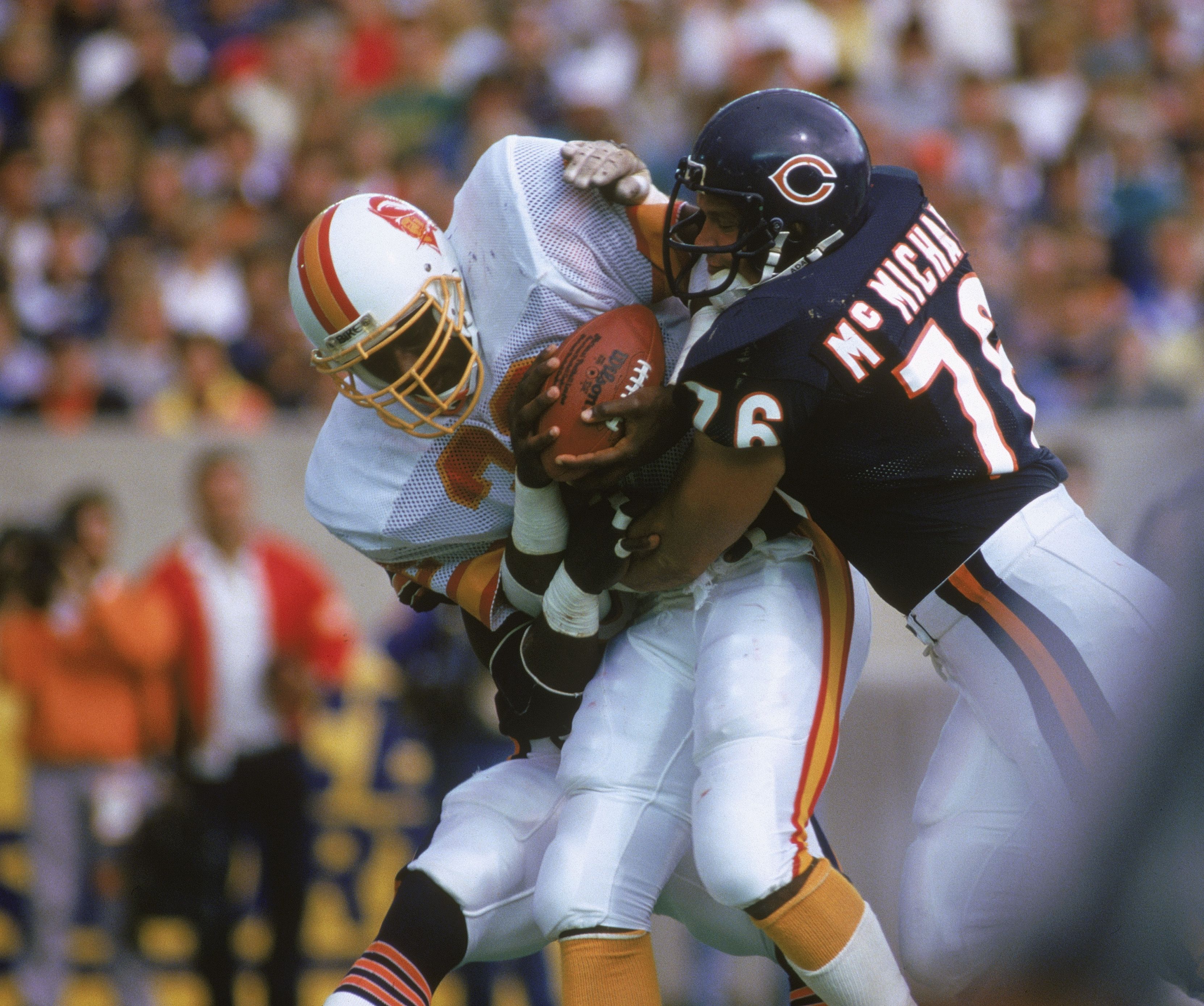 Photo of a player tackling another player on football field 