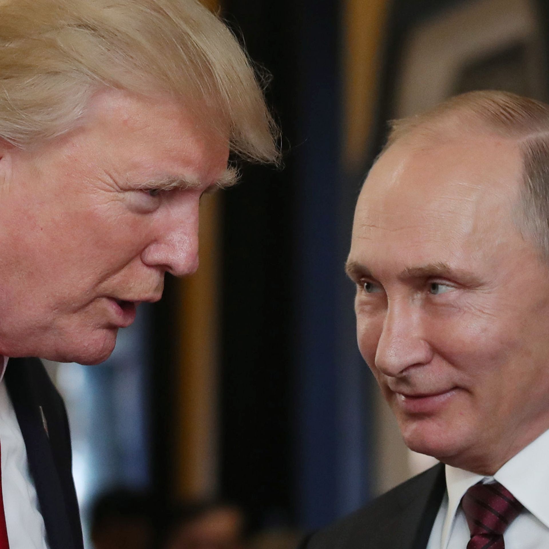 Trump and Putin facing each other in conversation