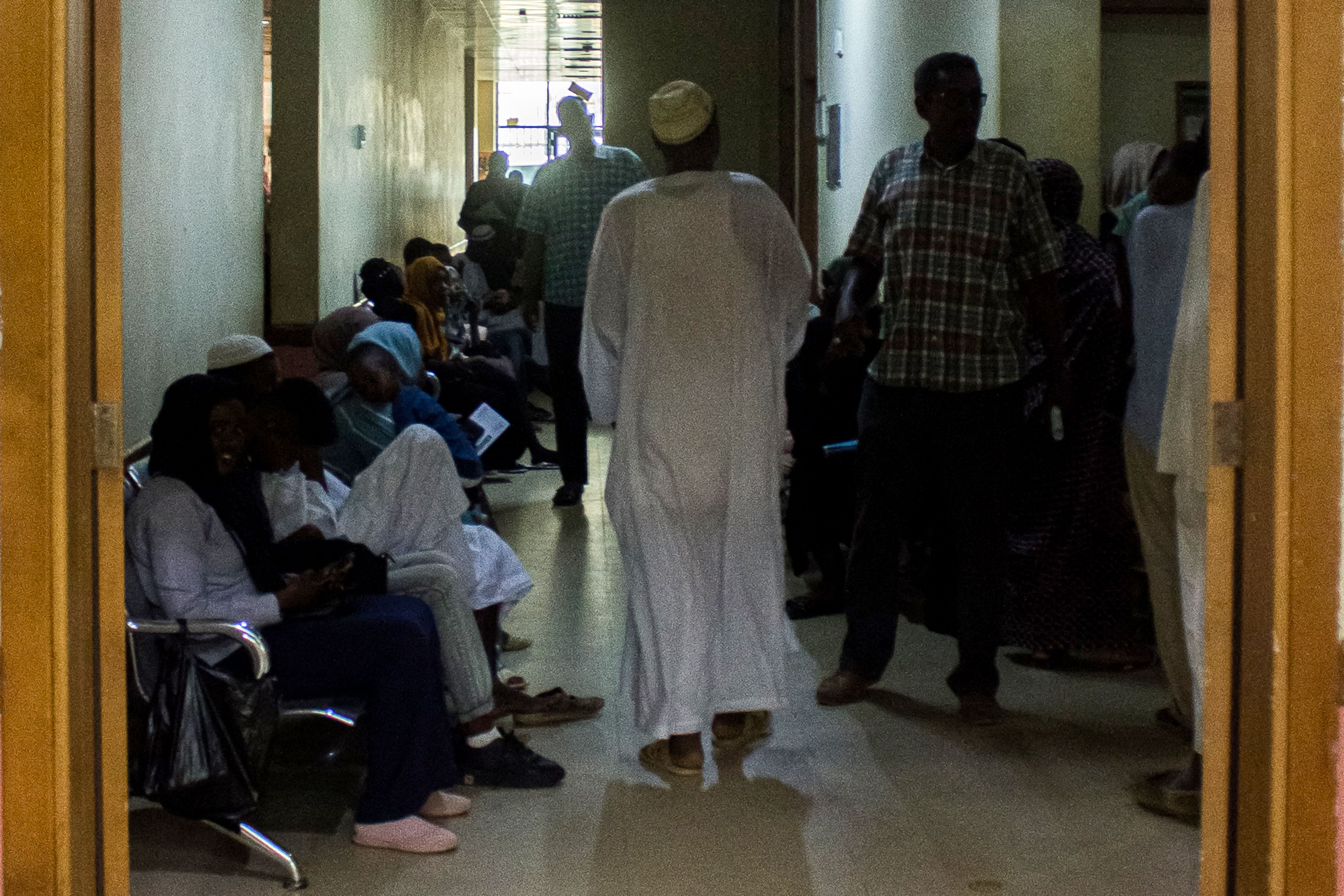 Patients wait outside the clinics at the Medani Heart Centre hospital in Wad Madani,