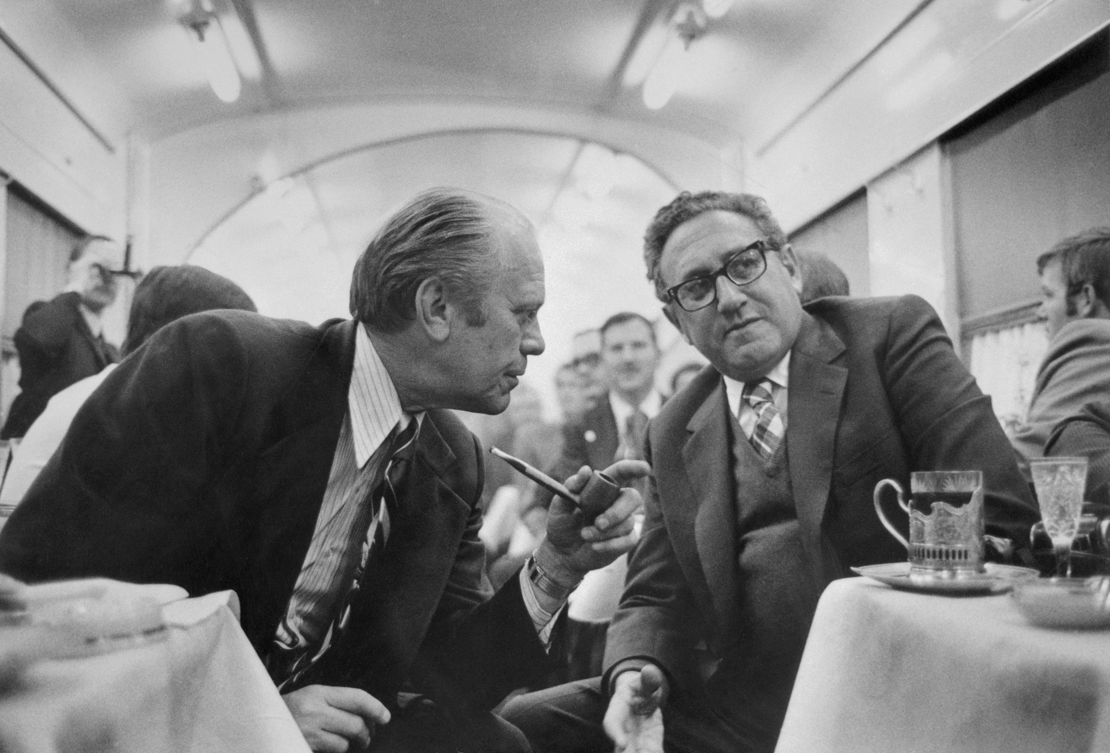 ) In the dining car on the train from Vladivostok to the airport on November 23, 1974, President Gerald Ford discusses progress on the S.A.L.T. agreement with Secretary of State Henry Kissinger.