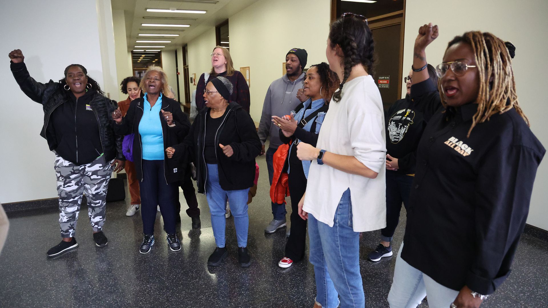 Photo of people shouting in a hallway