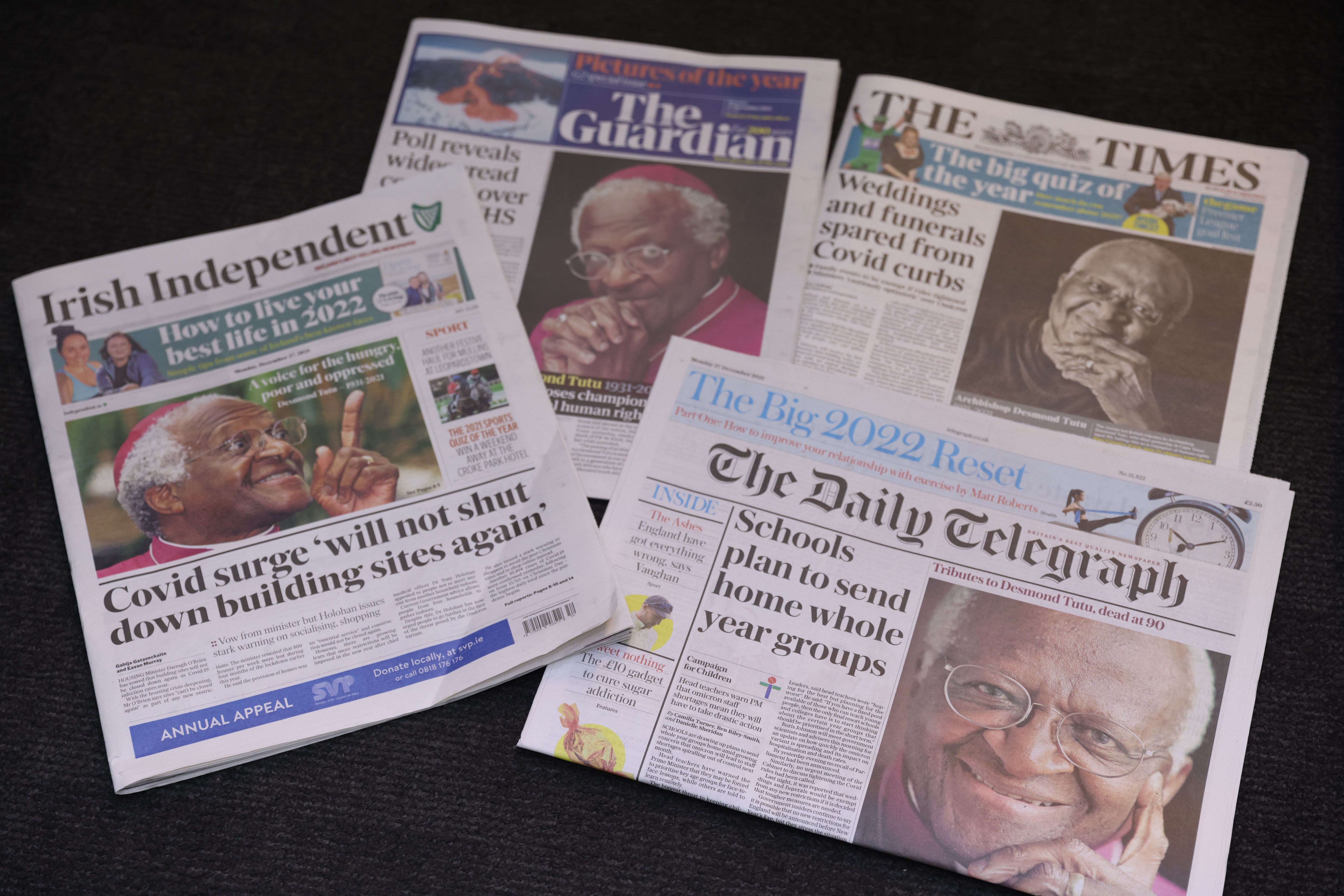 This photo illustration shows an assortment of newspaper front pages featuring Desmond Tutu, including The Guardian, The Times, The Daily Telegraph and the Irish Independent's.