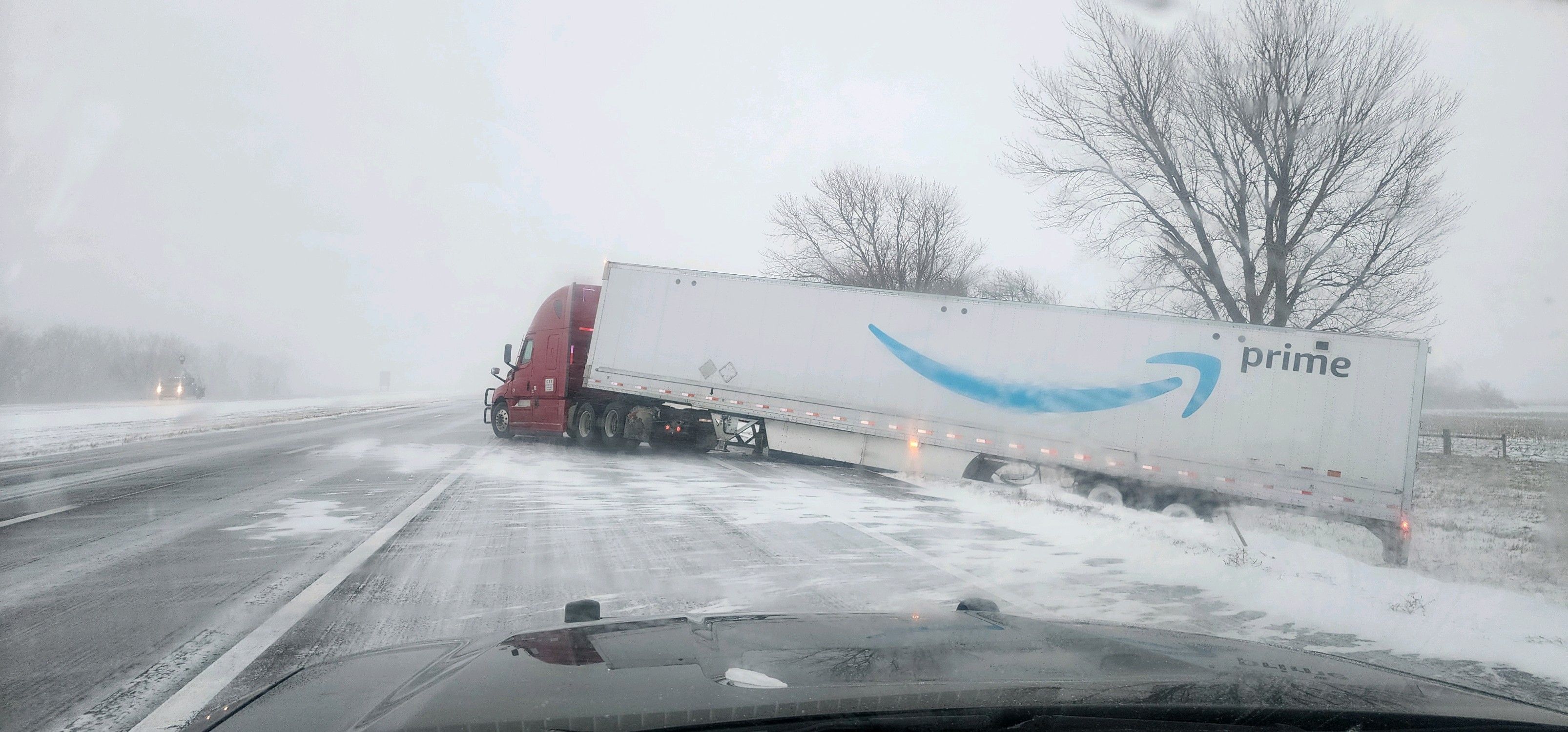 Truck slides off the highway due to icy conditions