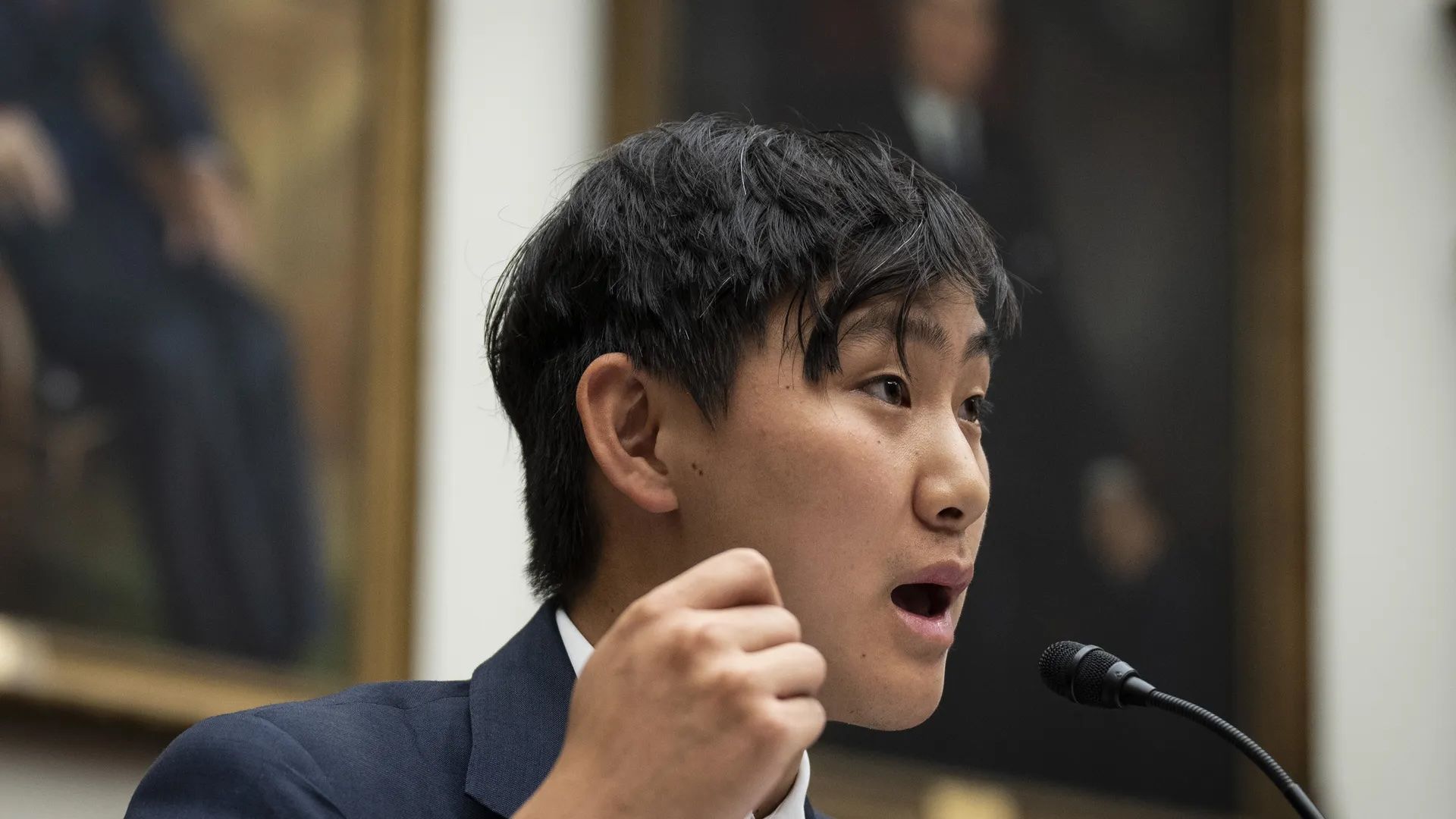 Photo of Scale AI CEO Alexandr Wang testifying before Congress, speaking at a microphone