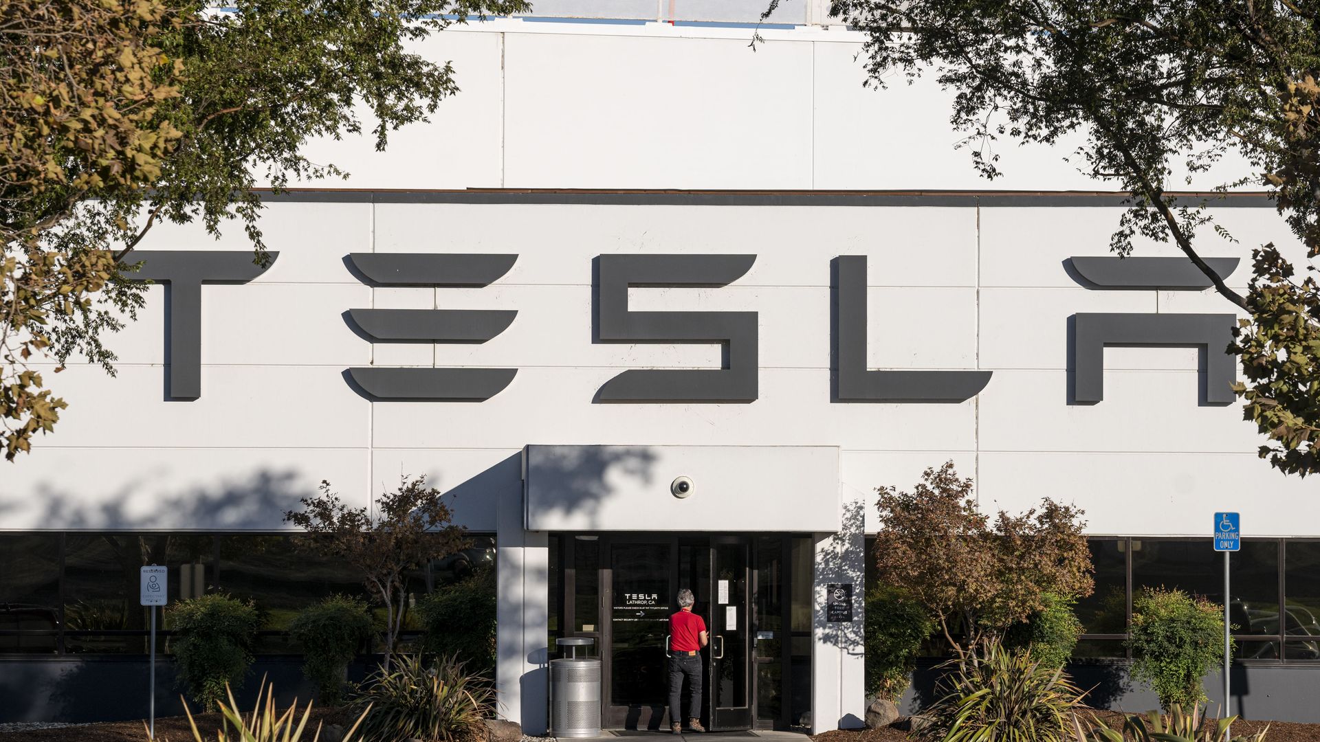 A person entering a Tesla factory in Lathrop, California, in September 2021.