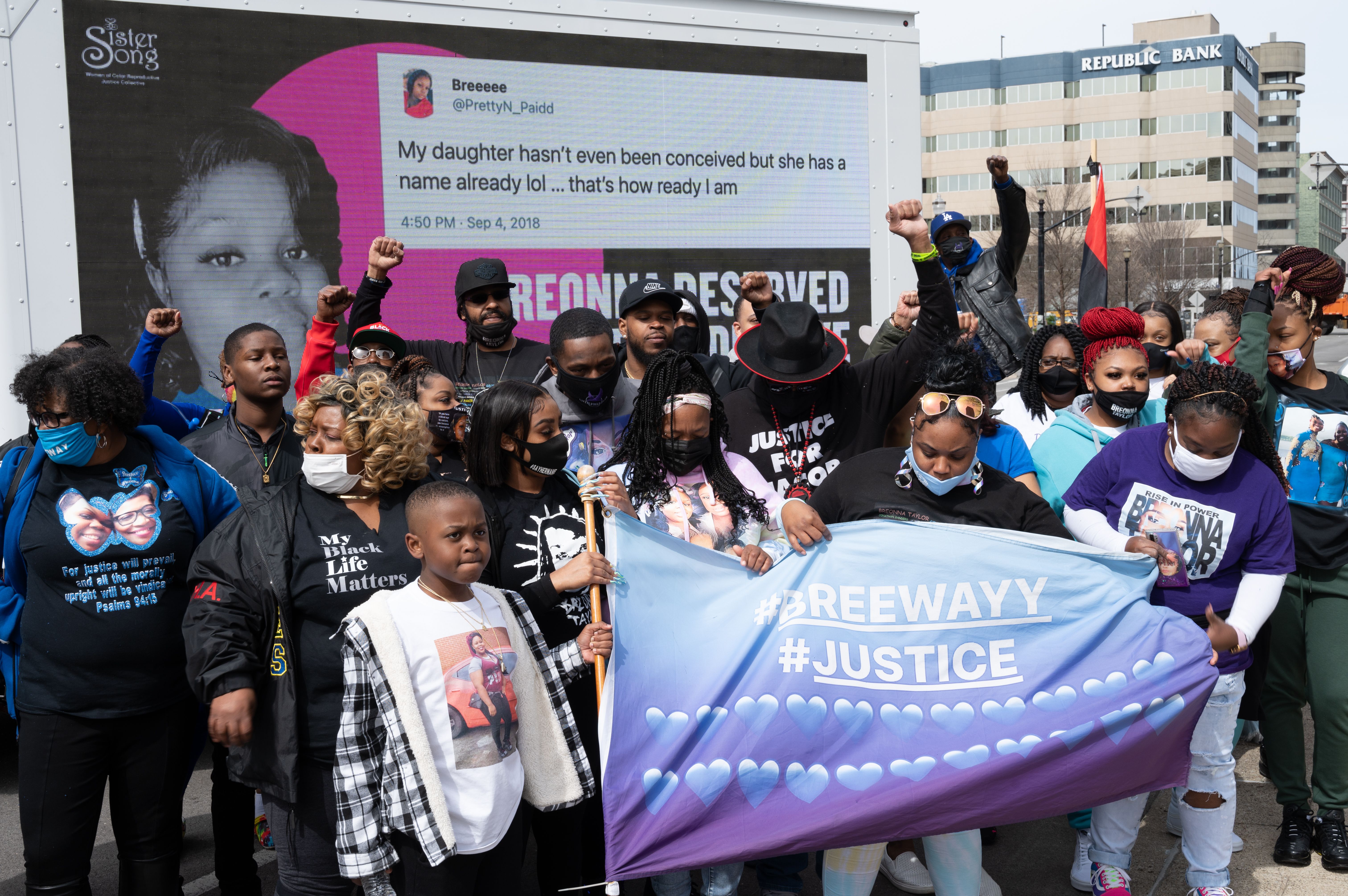  Tamika Palmer (C), mother of Breonna Taylor and others stand with their fists up before a mobile billboard near Jefferson Square Park on March 13, 2021 in Louisville, Kentucky. 