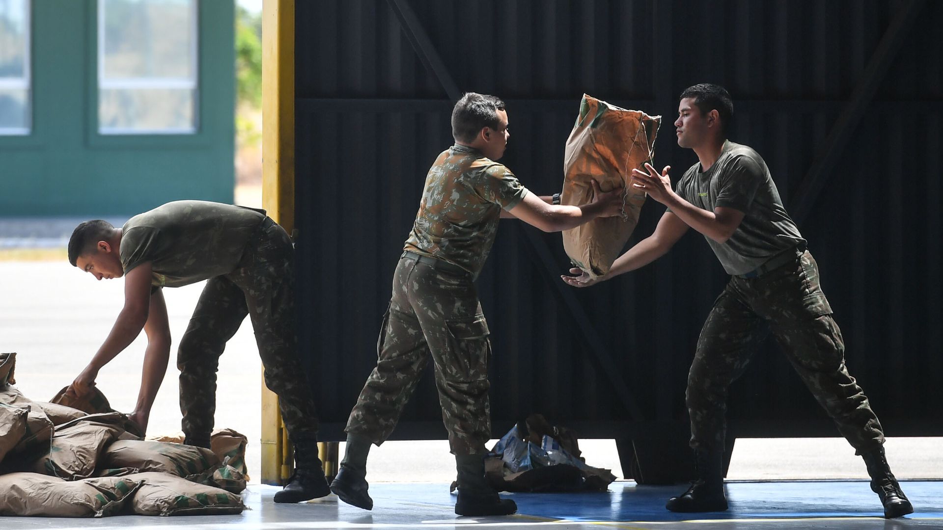 Brazilian soldiers organize sacks of powdered milk that are part of the humanitarian aid for Venezuela