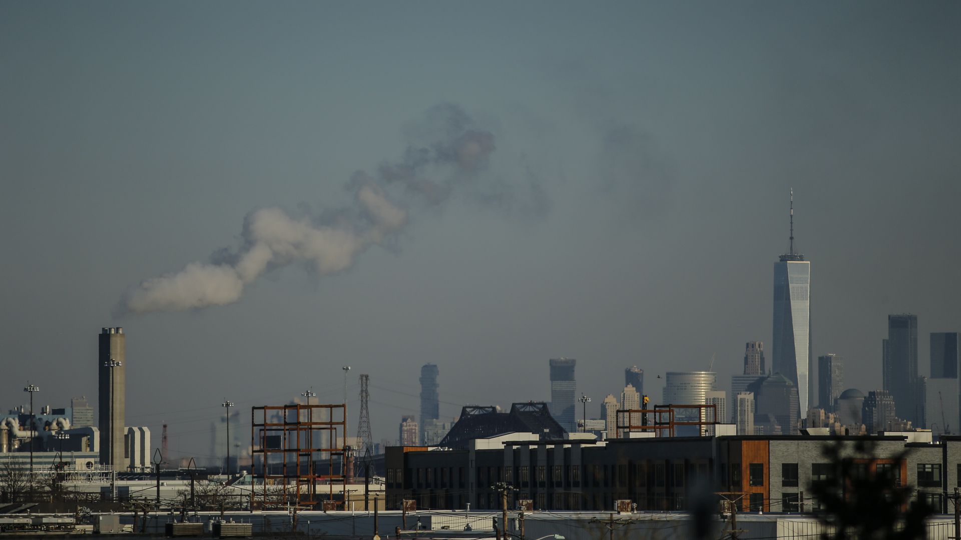 The One World Trade center is seen as a factory emits smoke on January 18, 2018 from Newark, New Jersey.