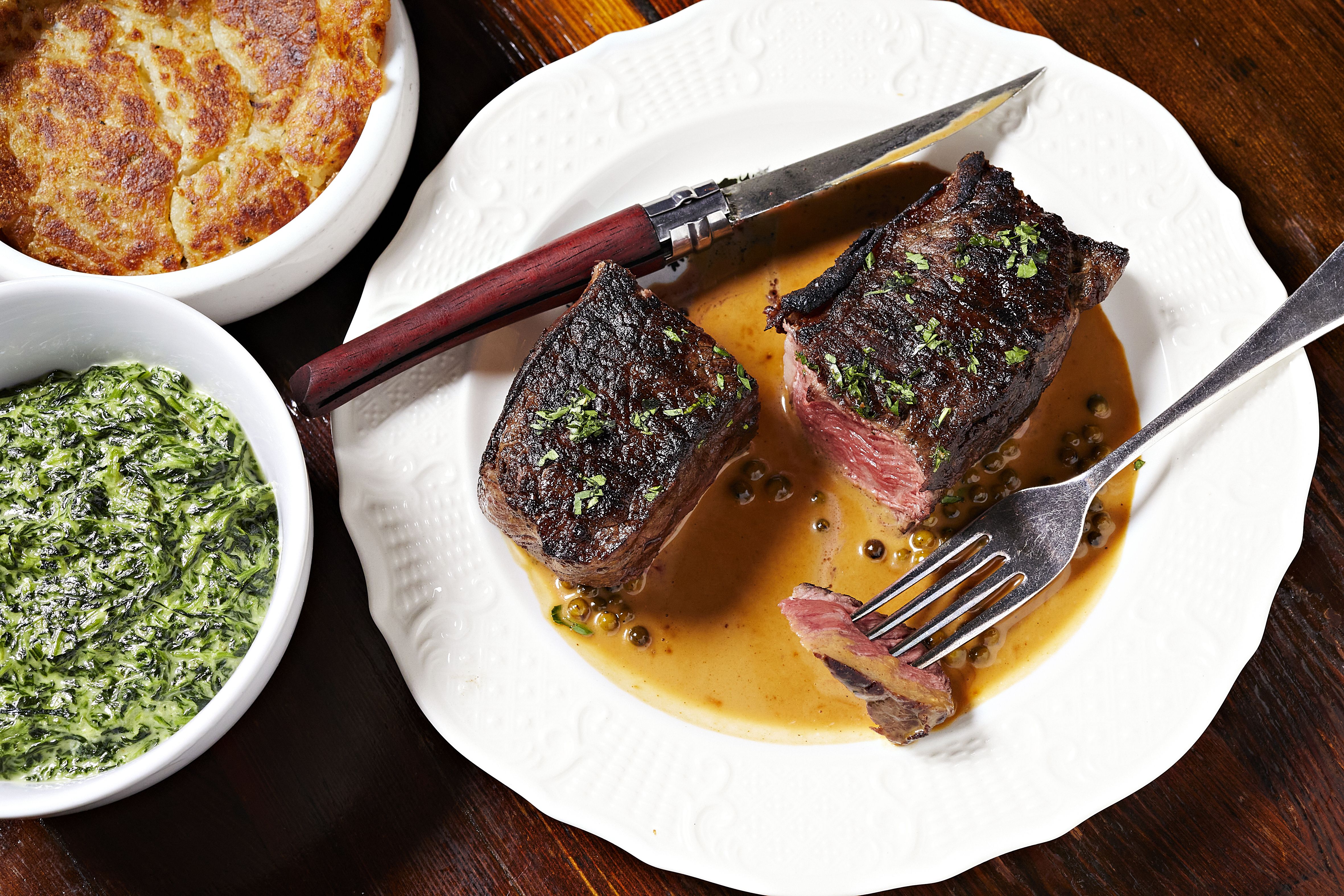 NY Strip with au poivre sauce and sides of creamy spinach and pan-fried mashed potatoes at St. Anselm photographed in Washington, DC on July 19, 2024. (Photo by Deb Lindsey for The Washington Post via Getty Images).