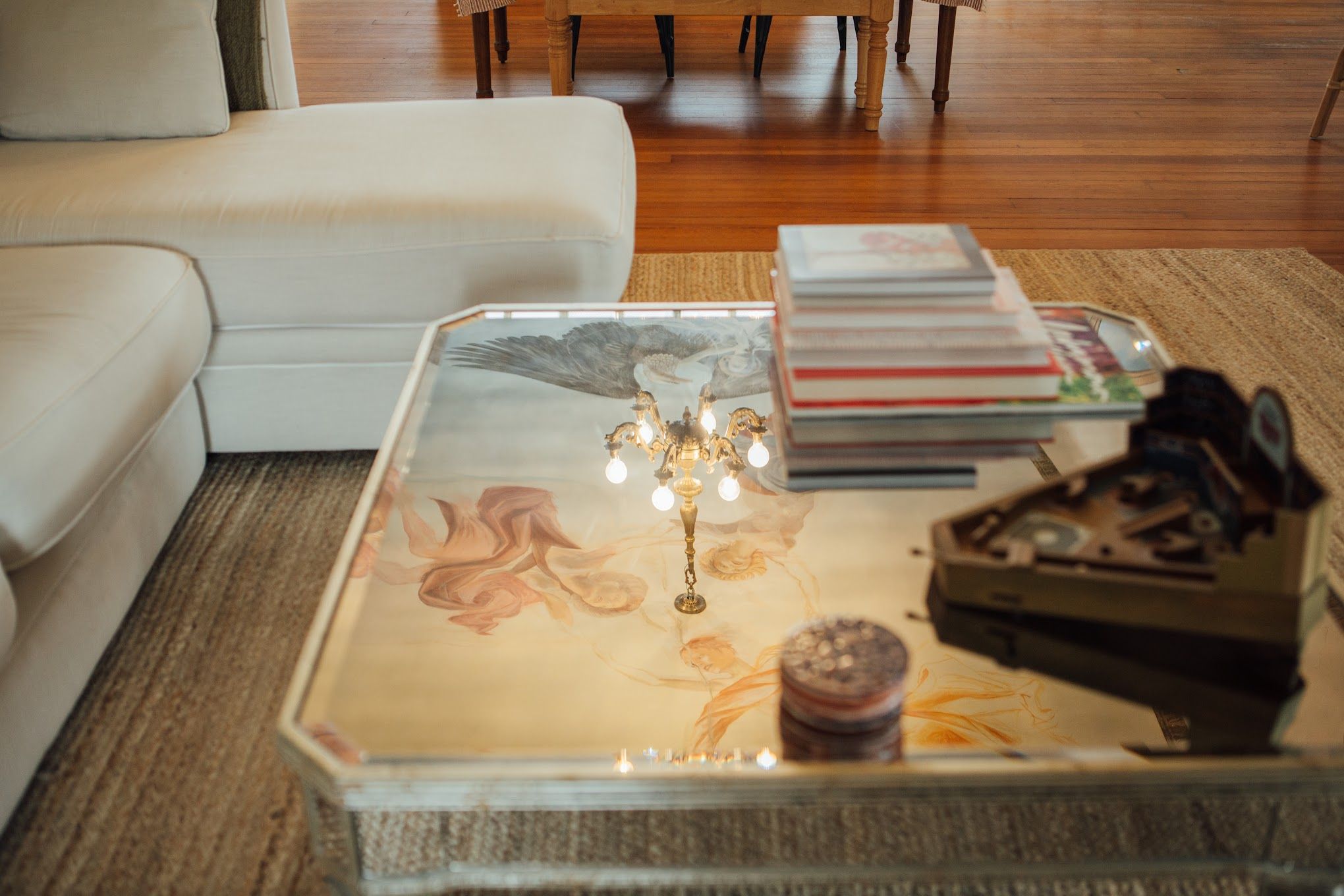 A photo of a coffee table reflecting murals of angels on the ceiling.